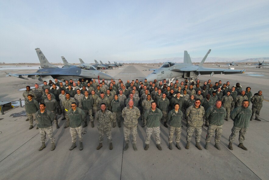 Members of the 482nd Maintenance Group and Detachment 93, 495th Fighter Group from Homestead Air Reserve Base, Fla. stand in front of an F-16 and F-18 at Naval Air Station Fallon, Nev., on Dec. 11. Over 150 Homestead ARB personnel are deployed to NAS Fallon for two weeks of training. (U.S. Navy photo by Mass Communications Specialist 1st Class Terry Matlock)