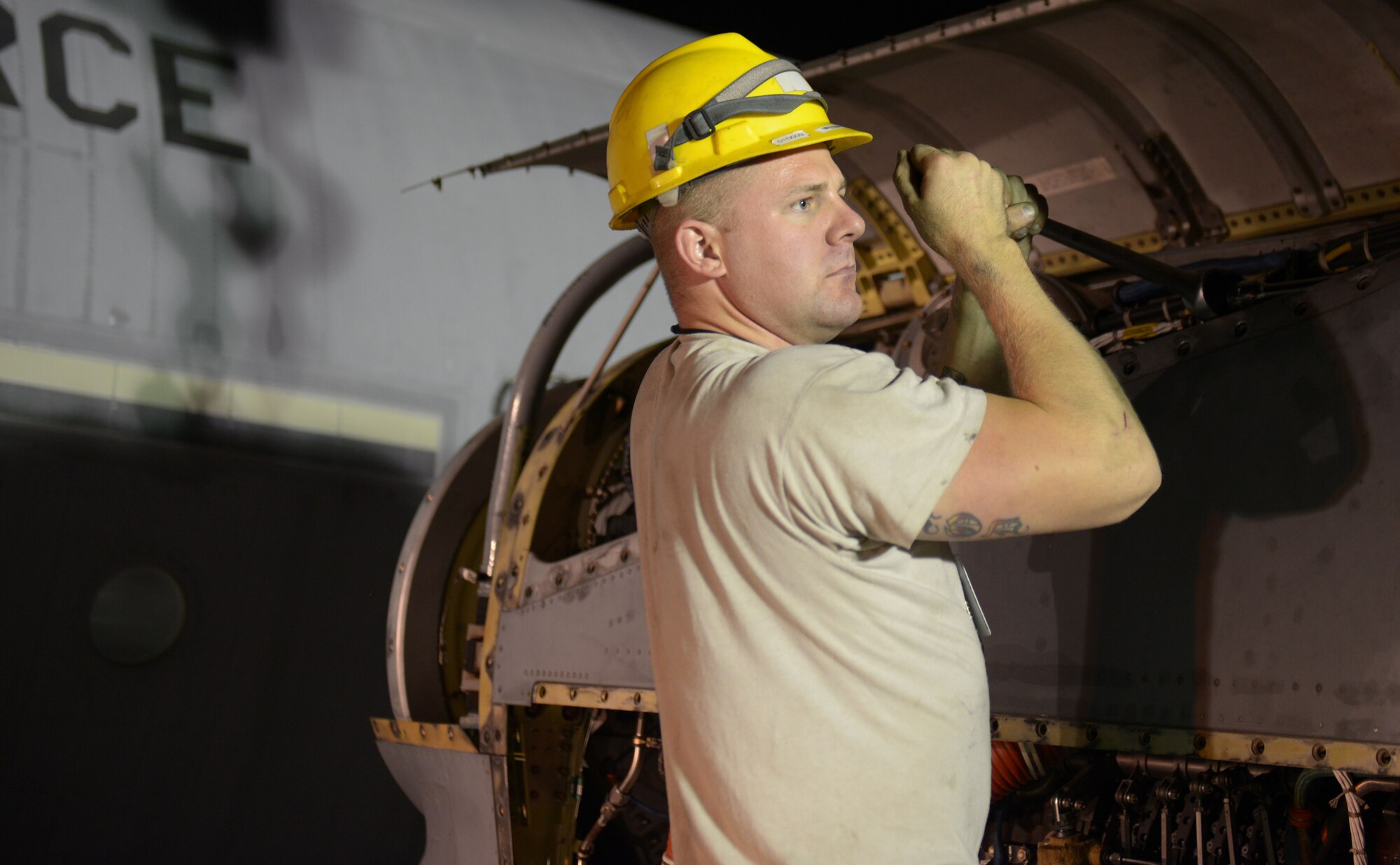 Senior Airman Phillip Swensen, 379th Expeditionary Aircraft Maintenance Squadron, 746th Expeditionary Aircraft Maintenance Unit propulsion journeyman, tightens a C-130 engine on to an engine stand at the 379th Air Expeditionary Wing, Southwest Asia, Dec. 11, 2013. The C-130 engine was changed out in 12 hours and the aircraft ready to fly on schedule. Swensen is deployed from Keesler Air Force Base, Miss., and a Rohnert Park, Calif., native. (U.S. Air Force photo/Master Sgt. David Miller)