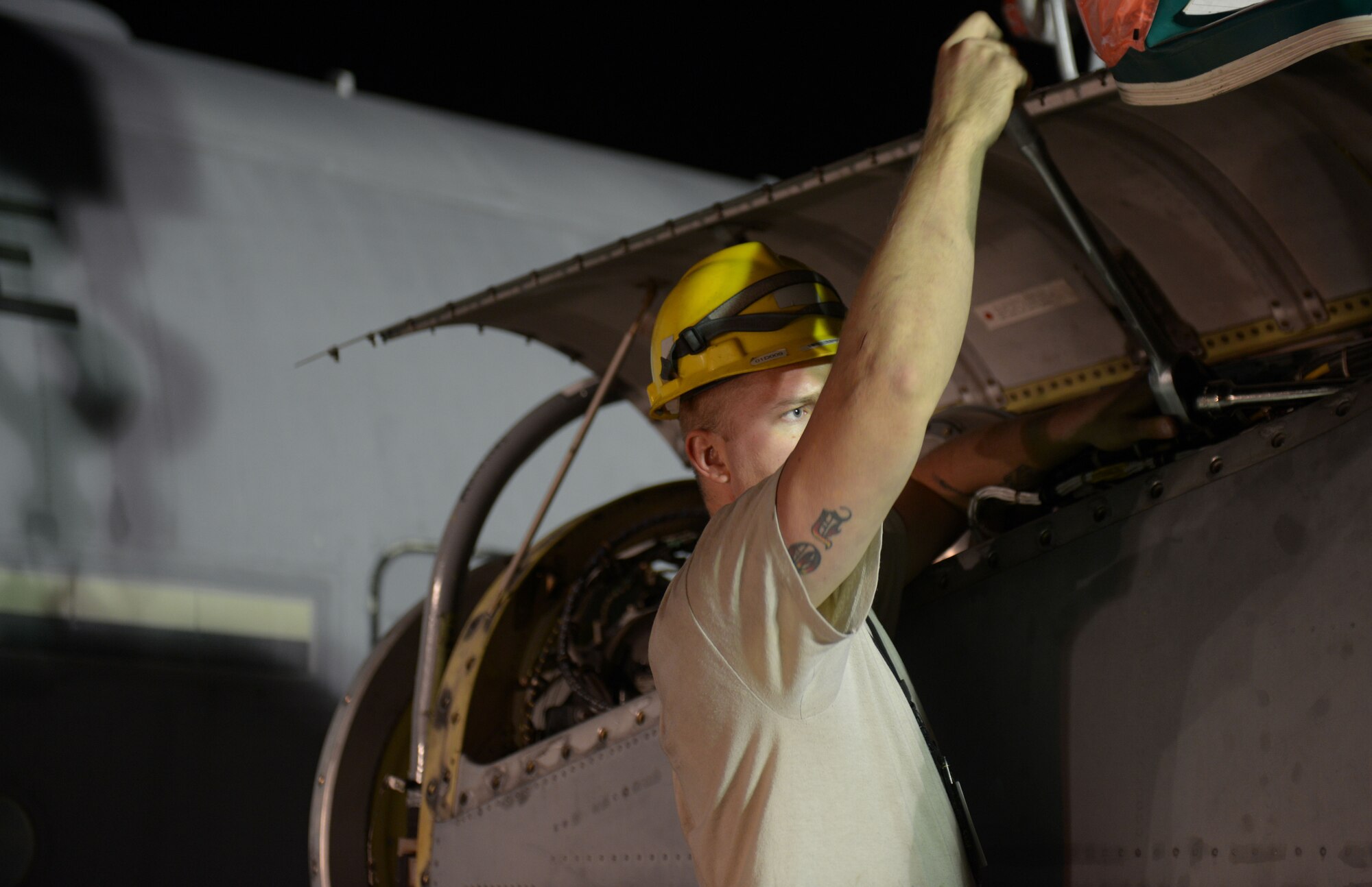 Senior Airman Phillip Swensen, 379th Expeditionary Aircraft Maintenance Squadron, 746th Expeditionary Aircraft Maintenance Unit propulsion journeyman, tightens a C-130 engine on to an engine stand at the 379th Air Expeditionary Wing, Southwest Asia, Dec. 11, 2013. The C-130 engine was changed out in 12 hours and the aircraft ready to fly on schedule. Swensen is deployed from Keesler Air Force Base, Miss., and a Rohnert Park, Calif., native. (U.S. Air Force photo/Master Sgt. David Miller)