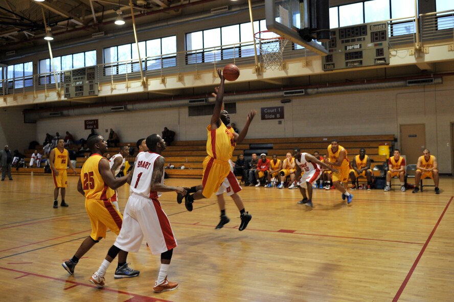 A Suwon basketball team member shoots while attempting to score two points during the Pacific Holiday Basketball Tournament at Osan Air Base, Republic of Korea, Dec. 12, 2013. Teams from Anderson Air Force Base, Guam,  Kadena AB, Japan, and other bases on the Korean peninsula participated in the annual tournament. (U.S. Air Force photo/Staff Sgt. Emerson Nuñez)