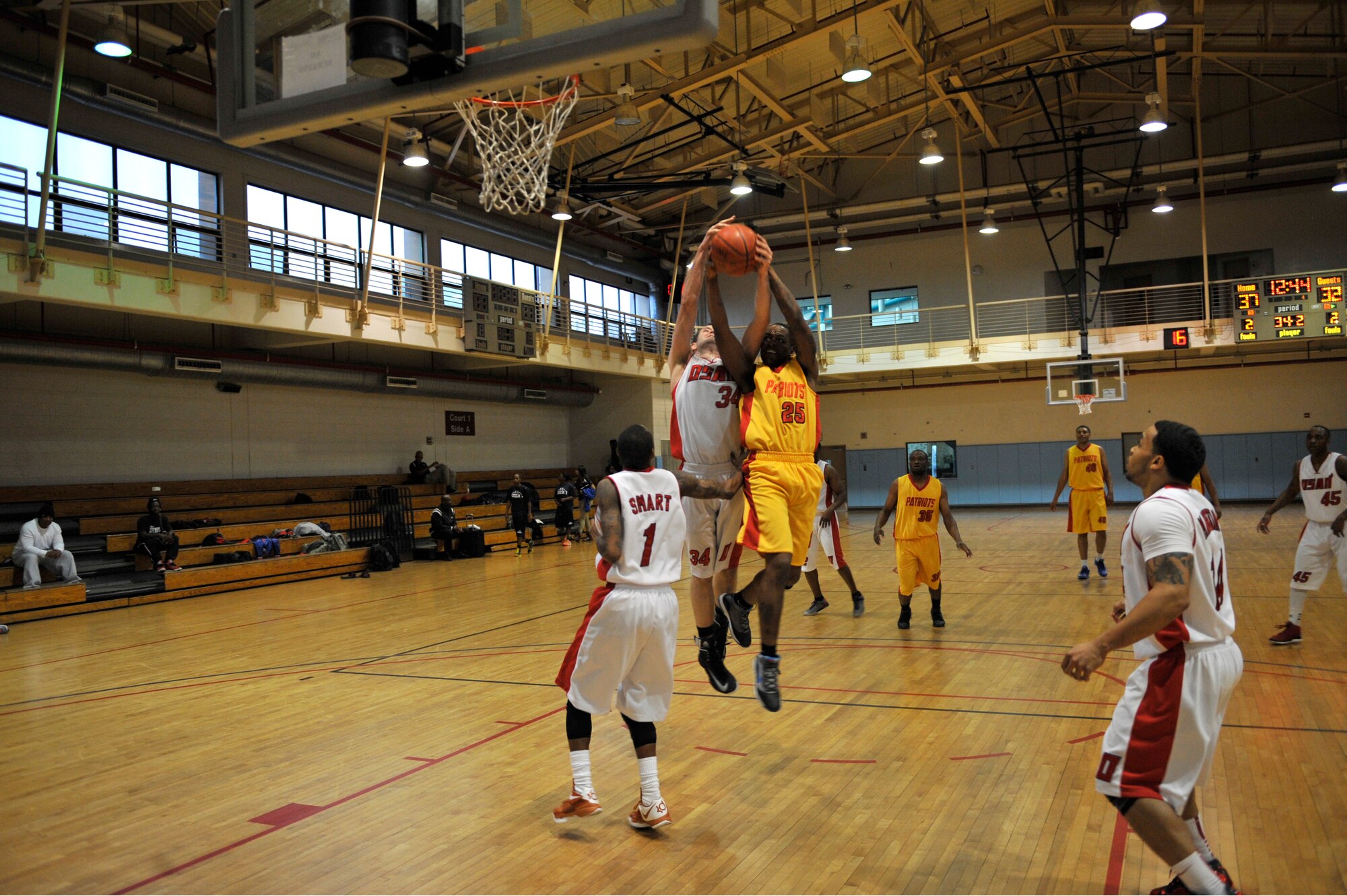 Osan and Suwon basketball team members fight for the rebound during the Pacific Holiday Basketball Tournament at Osan Air Base, Republic of Korea, Dec. 12, 2013. The tournament is open to all Pacific Air Force teams.  (U.S. Air Force photo/Staff Sgt. Emerson Nuñez)