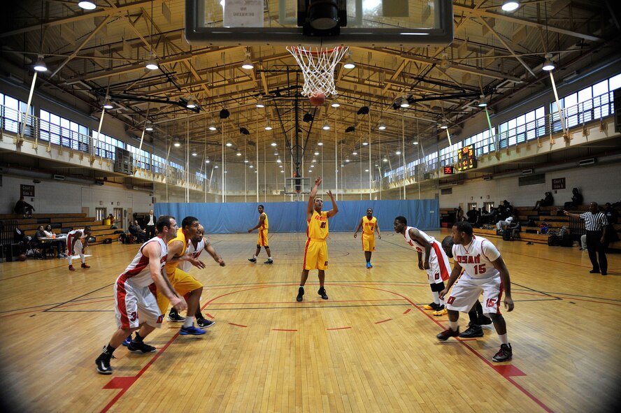 Osan and Suwon basketball team members prepare to box each other out as a free throw shot is taken during the Pacific Holiday Basketball Tournament at Osan Air Base, Republic of Korea, Dec. 12, 2013. The Osan basketball team won the first game 63-50. (U.S. Air Force photo/Staff Sgt. Emerson Nuñez)