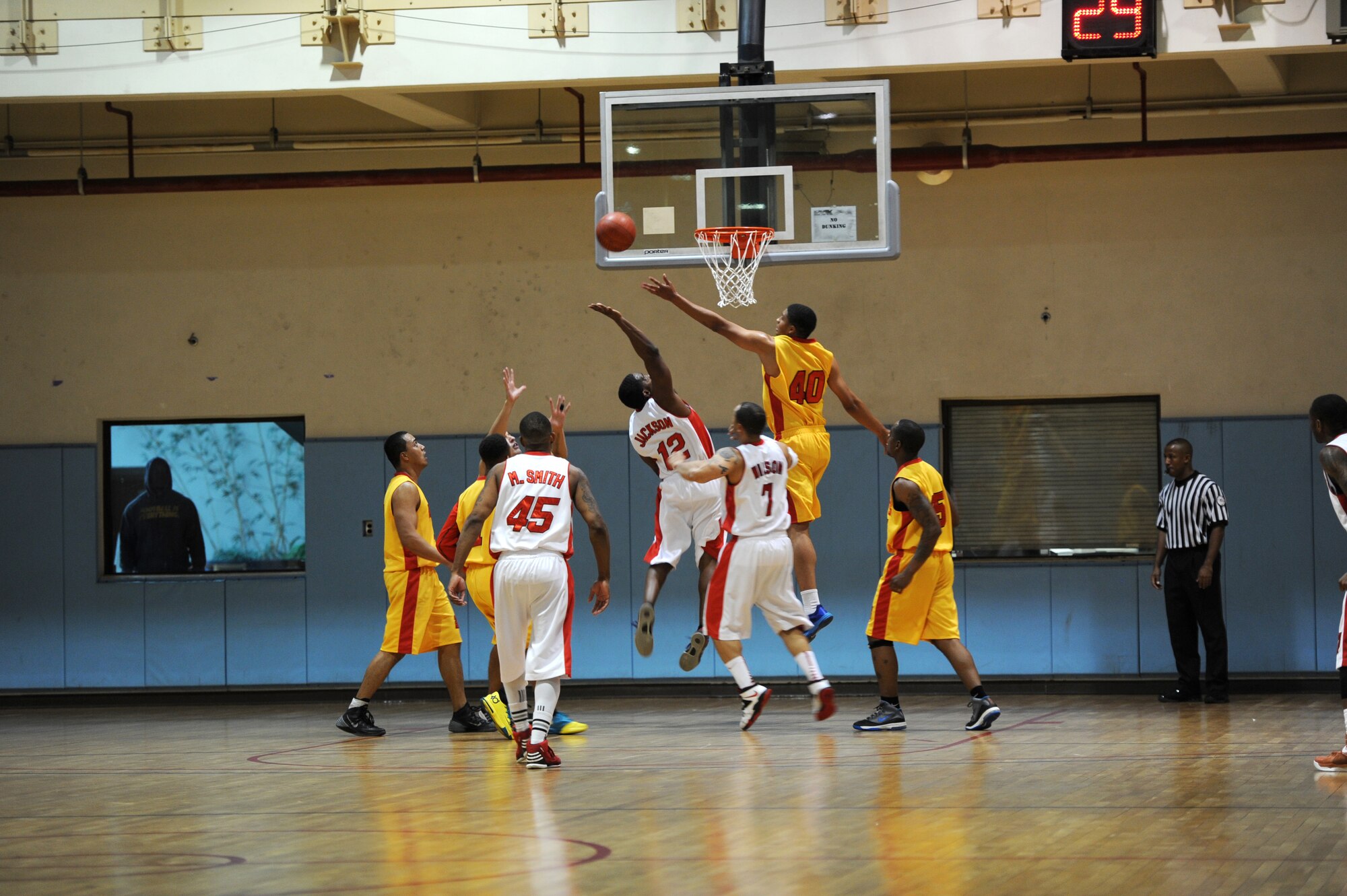 Osan and Suwon basketball team members try to recover the rebound during the Pacific Holiday Basketball Tournament at Osan Air Base, Republic of Korea, Dec. 12, 2013. There are a total of 13 teams competing in the tournament. (U.S. Air Force photo/Staff Sgt. Emerson Nuñez)