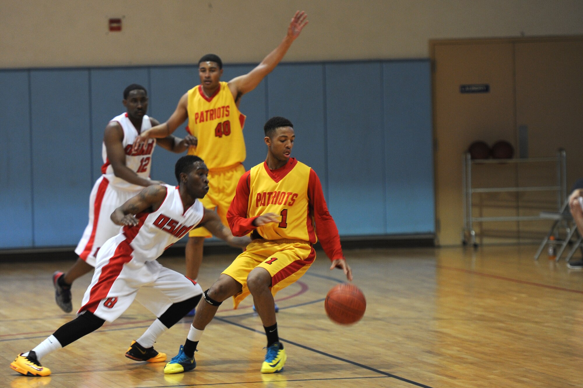 An Osan basketball team member attempts to steal the ball from a member of the Suwon basketball team during the Pacific Holiday Basketball Tournament at Osan Air Base, Republic of Korea, Dec. 12, 2013. Twenty-three games will be played before the final championship game Dec. 15.  (U.S. Air Force photo/Staff Sgt. Emerson Nuñez)