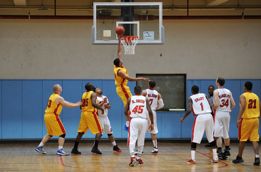 A member of the Suwon basketball team tips the ball into the hoop during the Pacific Holiday Basketball Tournament at Osan Air Base, Republic of Korea, Dec. 12, 2013. The Osan basketball team won the first game 63-50. (U.S. Air Force photo/Staff Sgt. Emerson Nuñez)