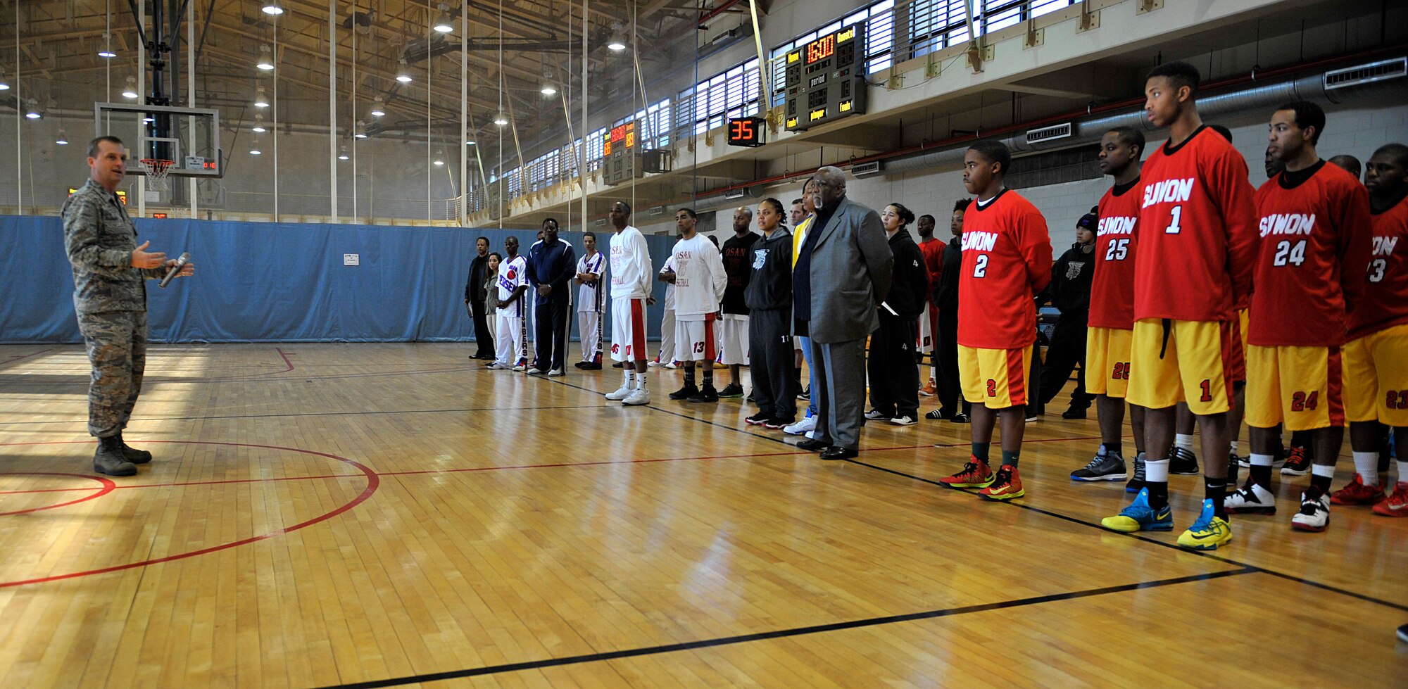 Col. James Clark, 51st Operations Group commander, speaks during the opening ceremonies of the Osan Pacific Holiday Basketball Tournament at Osan Air Base, Republic of Korea, Dec. 12, 2013.This is the 25th annual basketball tournament hosted by Osan. (U.S. Air Force photo/Staff Sgt. Emerson Nuñez)