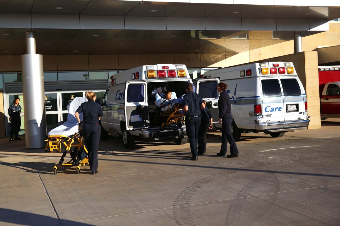 After being transported, Lance Cpl. Lucia Cabral is lowered from an ambulance by emergency medical technicians. The Naval Hospital Camp Pendleton facility, built in 1969, was officially decommissioned, requiring patients to be relocated to Pendleton’s recently built, 500,000-square foot, replacement hospital Dec. 14. The four-floor building cost $456 million and took more than three years to construct. Cabral is a maintenance management specialist with1st Marine Logistics Group. 