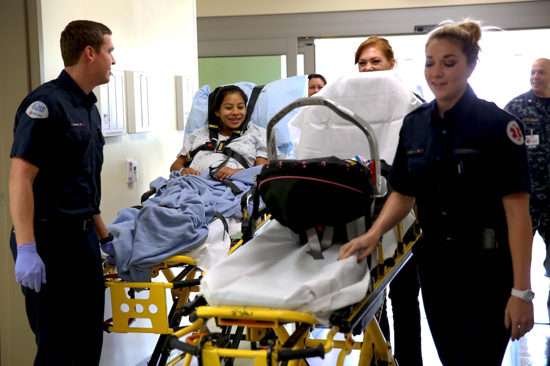 Emergency medical technicians escort Lance Cpl. Lucia Cabral and her newborn child to their room. The Naval Hospital Camp Pendleton facility, built in 1969, was officially decommissioned, requiring patients to be relocated to Pendleton’s recently built, 500,000-square foot, replacement hospital Dec. 14. The four-floor building cost $456 million and took more than three years to construct. Cabral is a maintenance management specialist with1st Marine Logistics Group. 