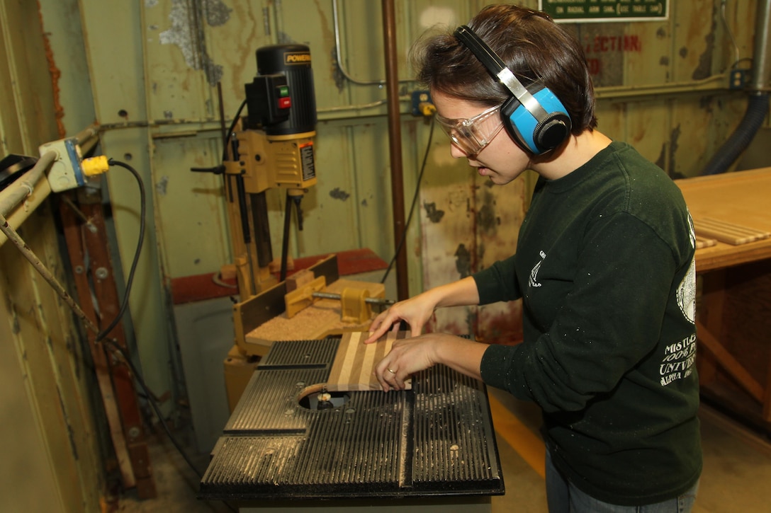 Jenny Cronin, spouse of 1st Lt. Justin Cronin, executive officer, D Company, 1st Tank Battalion, edges the corners on a wood project at the Combat Center’s Wood Hobby Shop to make cutting boards Dec. 8, 2013.


