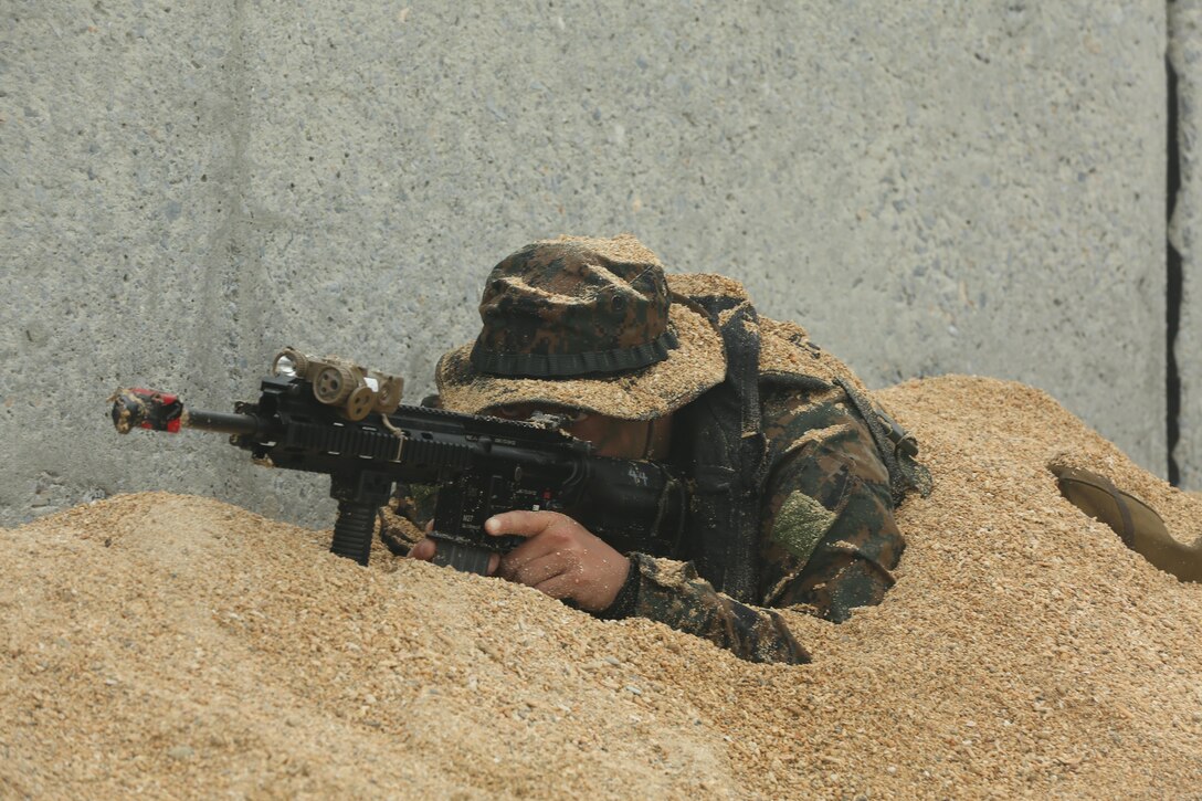 A Marine with Company F., Battalion Landing Team 2nd Battalion, 5th Marines, 31st Marine Expeditionary Unit, digs into a security position during a boat raid training event at Kin Blue beach, Dec. 11. The exercise was part of the 31st MEU’s pre-deployment training package designed to prepare the Marines for the upcoming theater security deployment. The 31st MEU is the Marine Corps’ force in readiness in the Asia-Pacific region and is the only continuously forward-deployed MEU.