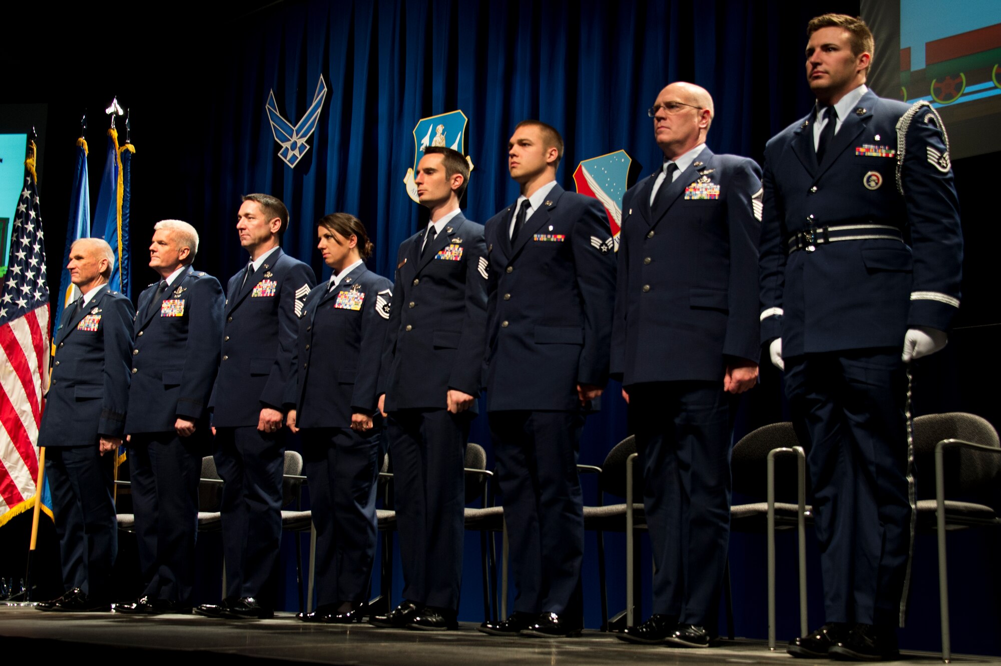Brig. Gen. Robert Cayton, left, Commander of the Minnesota Air National Guard and Chief of Staff Joint Forces Headquarters, Col. Jim Johnson, 133rd Airlift Wing Commander, and Chief Master Sgt. Paul Kessler recognize the 133rd Airlift Wing Outstanding Airman of the Year during  the annual Wing Awards Ceremony in St. Paul, Minn., Dec 14, 2013. Each awardee was presented with a crystal eagle, as a sign of their outstanding achievements. (U.S. Air National Guard photo by Staff Sgt. Austen Adriaens/Released)