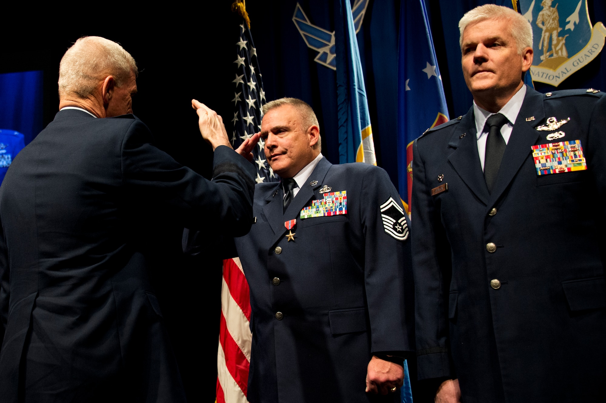Brig. Gen. Robert Cayton, left, Commander of the Minnesota Air National Guard and Chief of Staff Joint Forces Headquarters presents Senior Master Sgt. Darrin Ewing with the Bronze Star Medal at the annual 133rd Airlift Wing Awards Ceremony in St. Paul, Minn., Dec 14, 2013. Senior Master Sgt. Ewing was recognized with the bronze star upon completion of his deployment to Bagram Airfield, Afganistan. (U.S. Air National Guard photo by Staff Sgt. Austen Adriaens/Released)