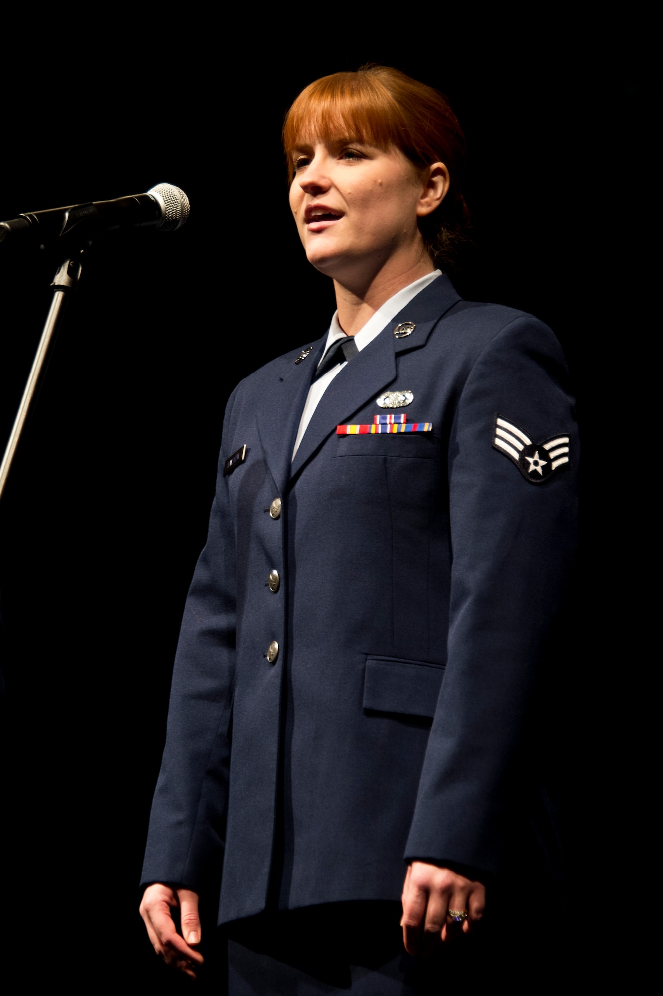 Senior Airman Jessica Lewellen sings the national anthem at the annual 133rd Airlift Wing Awards Ceremony in St. Paul, Minn., Dec 14, 2013. Senior Airman Lewellen has volunteered to perform the singing of the national anthem for the past 3 years. (U.S. Air National Guard photo by Staff Sgt. Austen Adriaens/Released)