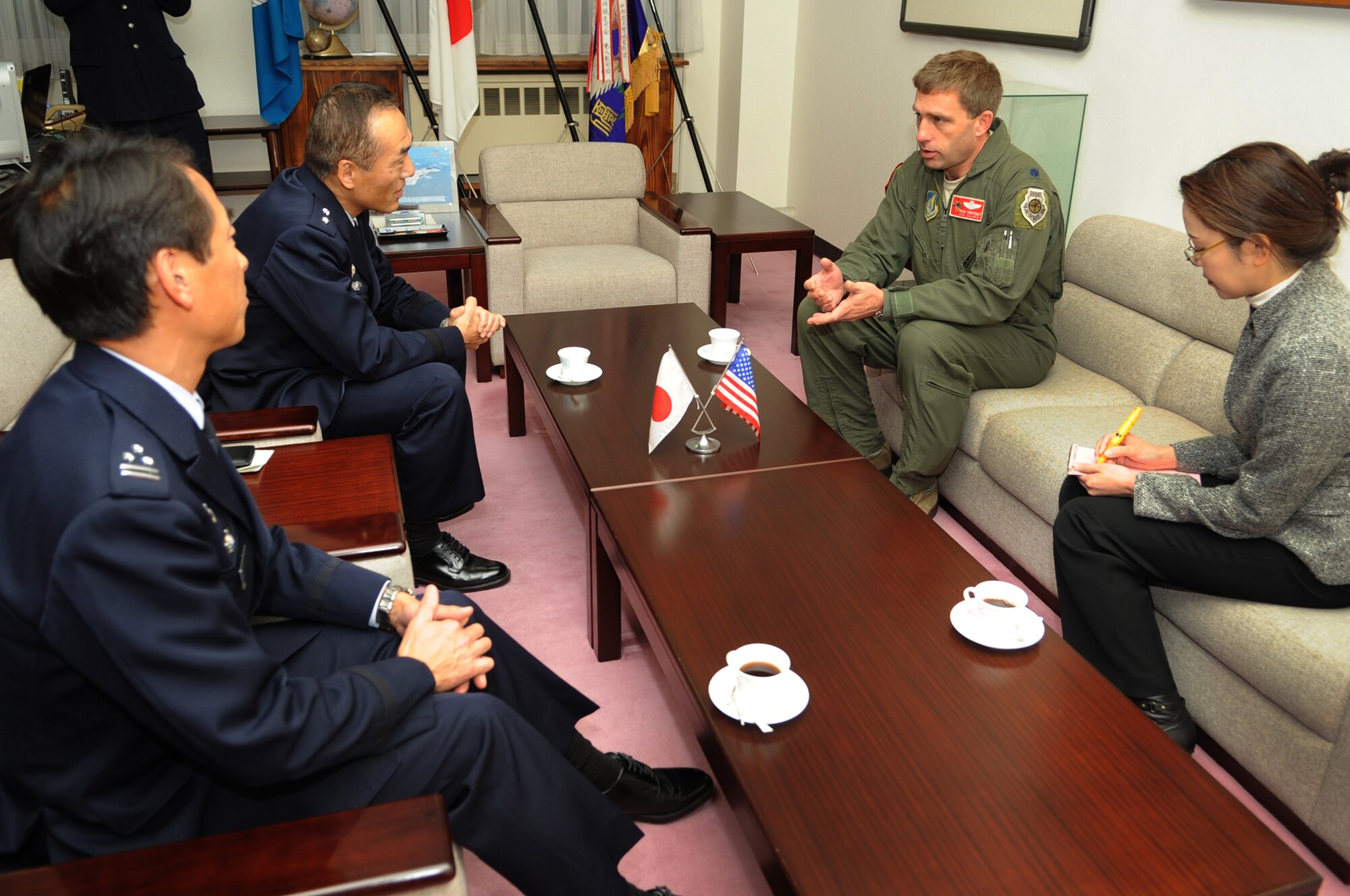 U.S. Air Force Lt. Col. Morris Fontenot, 67th Fighter Squadron commander, talks with Japanese Air Self Defense Force Maj. Gen. Yuich Yamamoto (center left), Komatsu Air Base and 6th Wing commander, during a meeting on Komatsu Air Base, Japan, Dec. 12, 2013. The 67th FS participated in a week-long bilateral Aviation Training Relocation Program with the JASDF 6th Wing 303rd and 306th Tactical Fighter Squadrons at Komatsu. The program emphasized interoperability training between U.S. and Japanese forces while promoting operational readiness. (U.S. Air Force photo by Staff Sgt. Amber E. N. Jacobs)