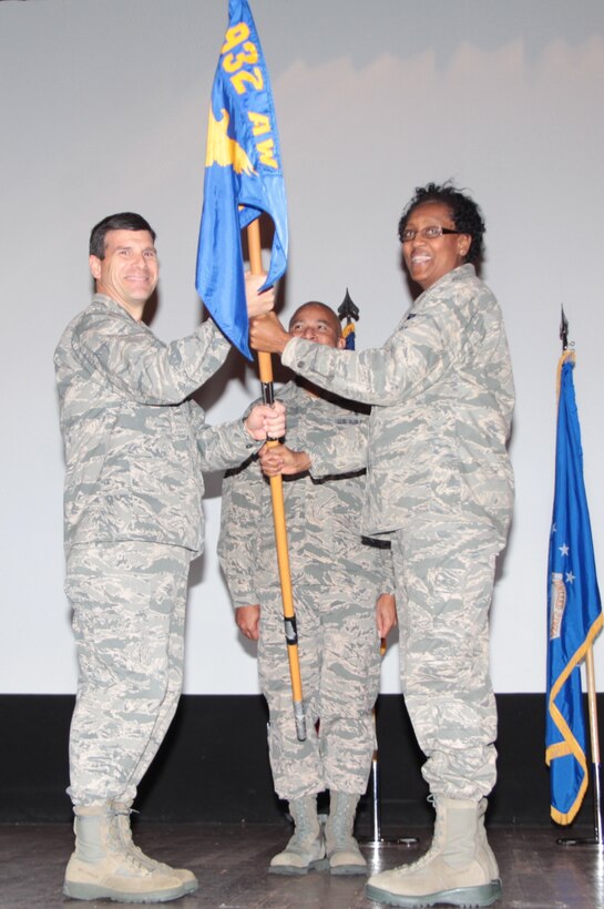Col. Albert Lupenski, commander of the 932nd Airlift Wing, passes the 932nd Airlift Wing Medical Group guidon to Col. Vanessa Mattox during the change of command ceremony. Mattox is taking command from Col. Arthur Nicholson.  (U.S. Air Force photo/Staff Sgt. Meiko Schill)