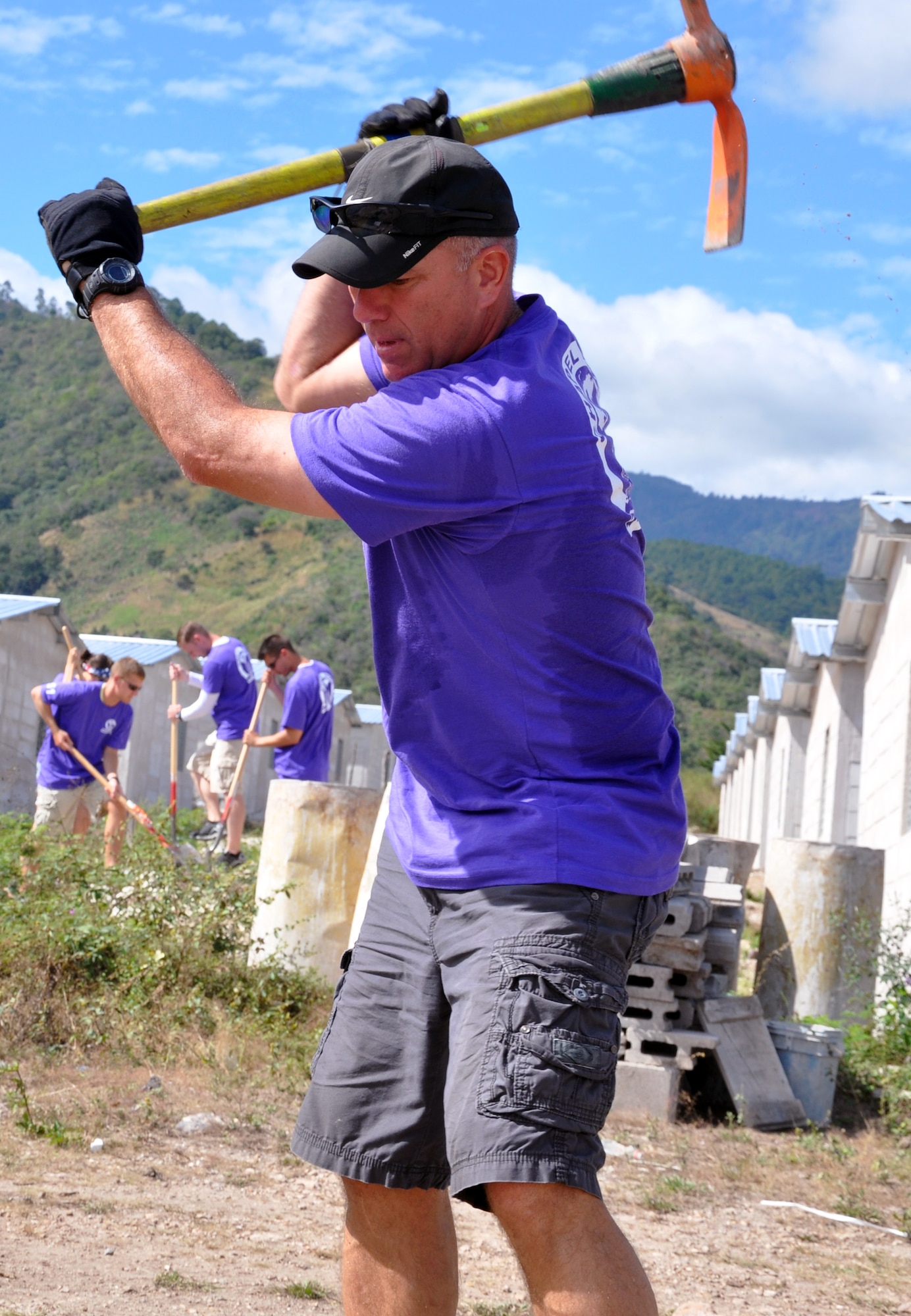 U.S. Army Col. Thomas Boccardi, Joint Task Force-Bravo Commander, works on clearing and leveling ground for housing in the village of Ajuterique in the Department of Comayagua, Honduras, during the 51st Joint Task Force-Bravo chapel hike, Dec. 14, 2013.  The Task Force members hiked three miles to the village to deliver more than 100 packs of food to families in the community, and then spent the remainder of their time working on a housing project in Ajuterique, doing manual labor to help build homes for families.  (U.S. Air Force photo by Capt. Zach Anderson)