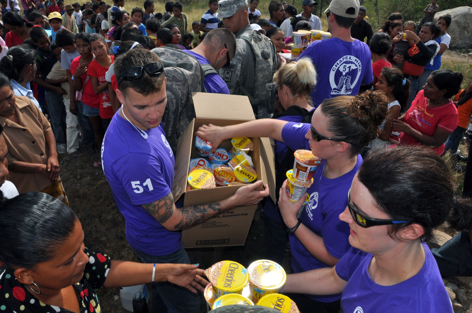Members of Joint Task Force-Bravo distribute food to families in need in the village of Ajuterique in the Department of Comayagua, Honduras, during the 51st Joint Task Force-Bravo chapel hike, Dec. 14, 2013.  The Task Force members hiked three miles to the village to deliver more than 100 packs of food to families in the community, and then spent the remainder of their time working on a housing project in Ajuterique, doing manual labor to help build homes for families.  (U.S. Air Force photo by Capt. Zach Anderson)
