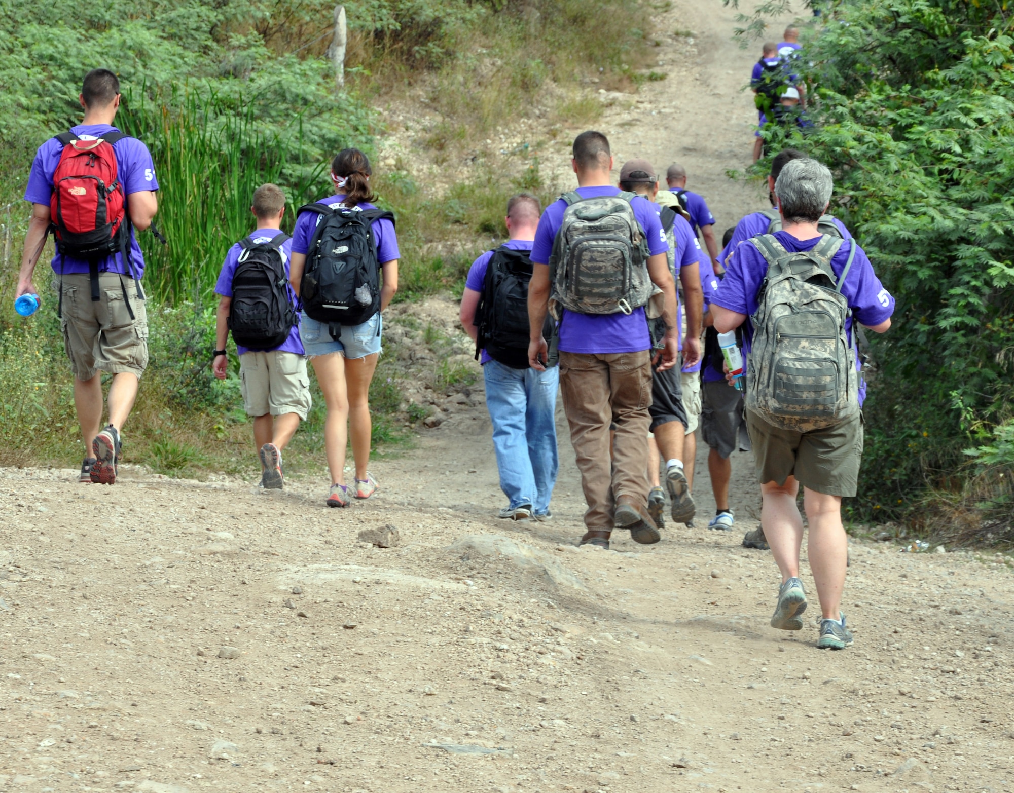 Members of Joint Task Force-Bravo make the three-mile hike to the village of Ajuterique in the Department of Comayagua, Honduras, as part of the 51st Joint Task Force Bravo Chapel Hike, Dec. 14, 2013.  The Task Force members delivered more than 100 packs of food to families in need in the community, then spent the remainder of their time working on a housing project in Ajuterique, doing manual labor to help build homes for families.  (U.S. Air Force photo by Capt. Zach Anderson)