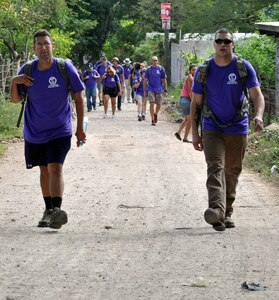 Members of Joint Task Force-Bravo make the three-mile hike to the village of Ajuterique in the Department of Comayagua, Honduras, as part of the 51st Joint Task Force Bravo Chapel Hike, Dec. 14, 2013.  The Task Force members delivered more than 100 packs of food to families in need in the community, then spent the remainder of their working on a housing project in Ajuterique, doing manual labor to help build homes for families.  (U.S. Air Force photo by Capt. Zach Anderson)