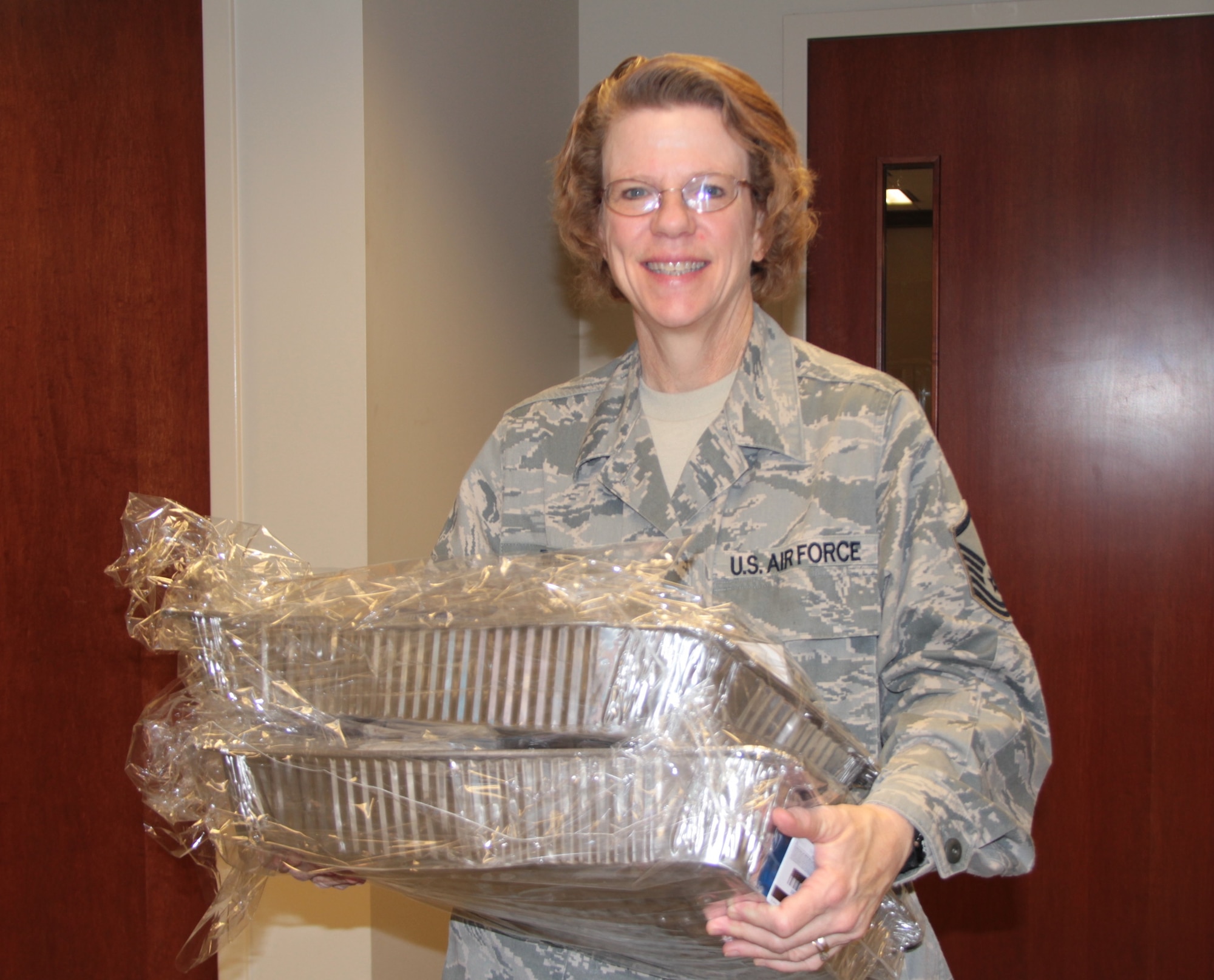 Master Sgt. Deborah Teague of the 932nd Airlift Wing's Family Readiness office delivers holiday dinner baskets to Air Force Reserve Command members. (Air Force photo by Staff Sgt. Meiko Schill.)