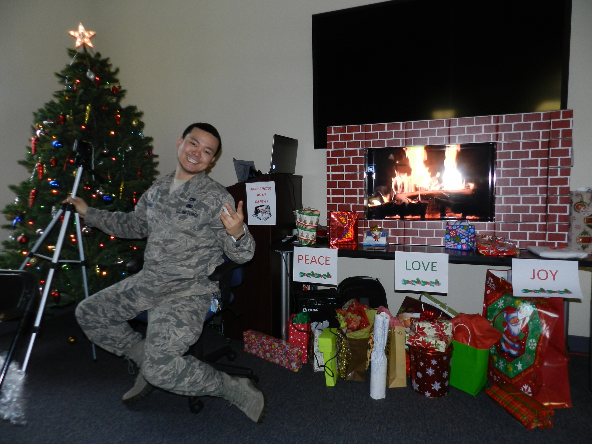 Senior Airman Donald Ramos, 514th Air Mobility Wing chaplain’s assistant and host, strikes a pose before the white elephant gift exchange held during the holiday lunch party Dec. 7 (U.S. Air Force photo/Tech Sgt. Jingwei Mai).