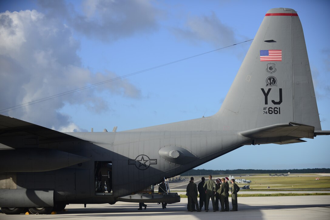 A C-130 Hercules crew from the 36th Airlift Squadron prepares for an airdrop mission during Operation Christmas Drop at Andersen Air Force Base, Guam, Dec. 11, 2013. This year marks the 62nd year of Operation Christmas Drop, which began in 1952, making it the world's longest running airdrop mission. Every December, C-130 Hercules crews from the 374th Airlift Wing at Yokota Air Base, Japan, partner with the 36th Wing at Andersen Air Force Base, Guam, to airlift food, supplies and toys to islanders throughout Micronesia. (U.S. Air Force photo by 2nd Lt. Jake Bailey/Released)