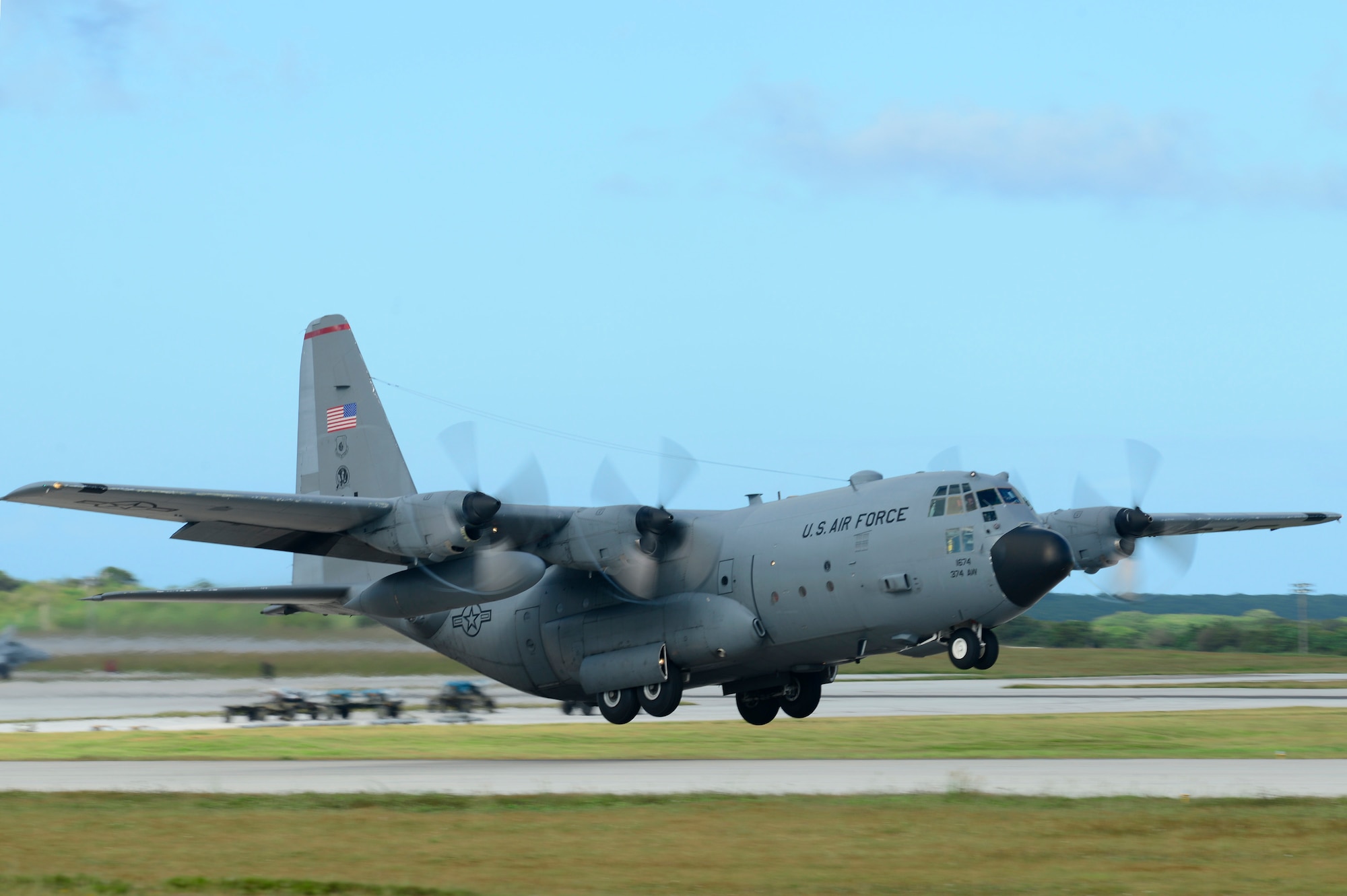 A C-130 Hercules aircraft from the 374th Airlift Wing, Yokota Air Base, Japan, takes off for an airdrop mission during Operation Christmas Drop at Andersen Air Force Base, Guam, Dec. 11, 2013. This year marks the 62nd year of Operation Christmas Drop, which began in 1952, making it the world's longest running airdrop mission. Every December, C-130 Hercules crews from the 374th Airlift Wing at Yokota Air Base, Japan, partner with the 36th Wing at Andersen Air Force Base, Guam, to airlift food, supplies and toys to islanders throughout Micronesia. (U.S. Air Force photo by 2nd Lt. Jake Bailey/Released)