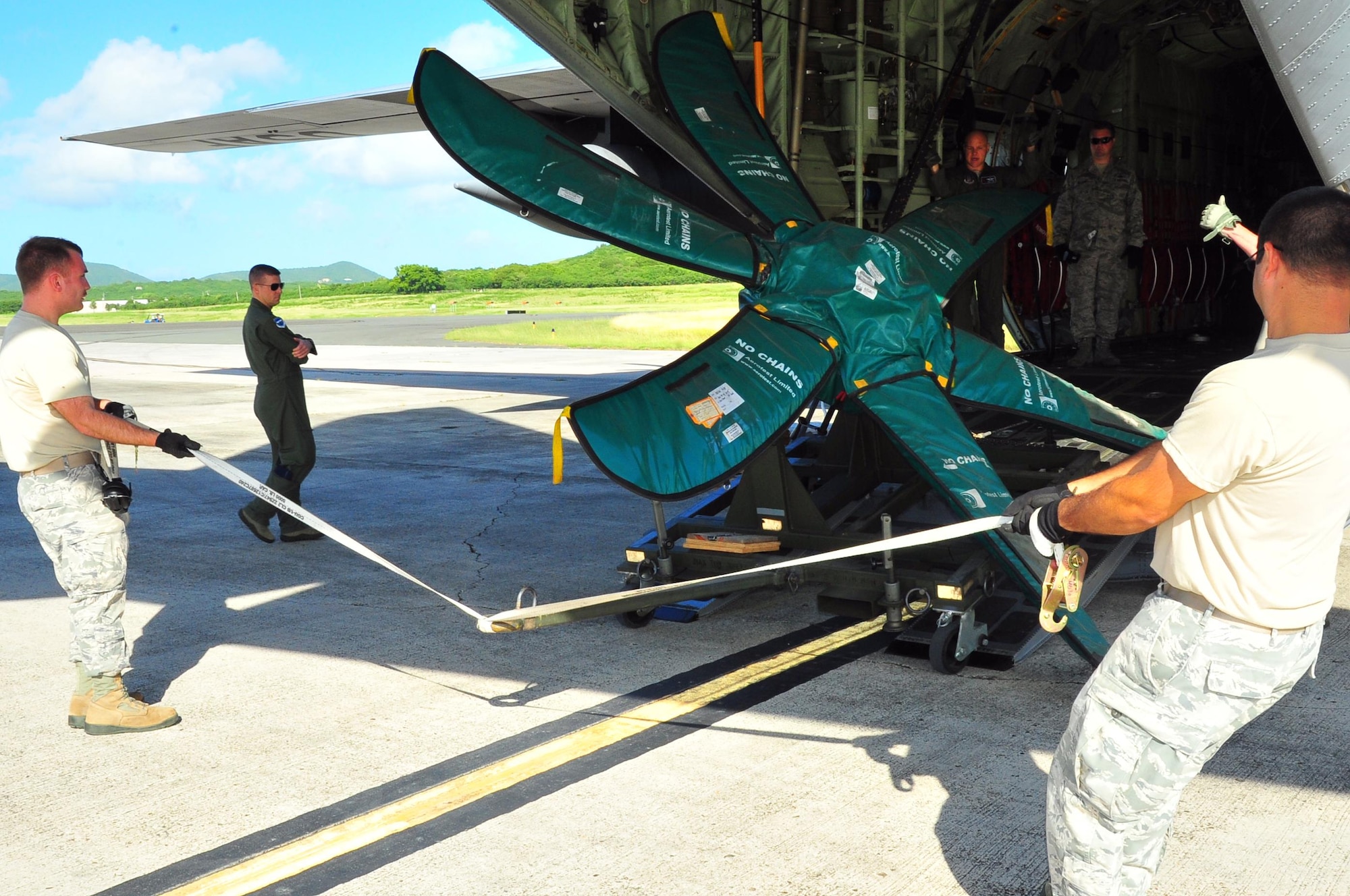 Reservists from the 403rd Wing, Keesler Air Force Base, Miss., load a propeller onto a WC-130J at Henry E. Rohlsen Airport, St. Croix, U.S. Virgin Islands, Dec. 12, 2013. Aircrews from the 53rd Weather Reconnaissance Squadron, known as the Hurricane Hunters, forward deploy to St. Croix to fly storms on the Atlantic side during hurricane season. 