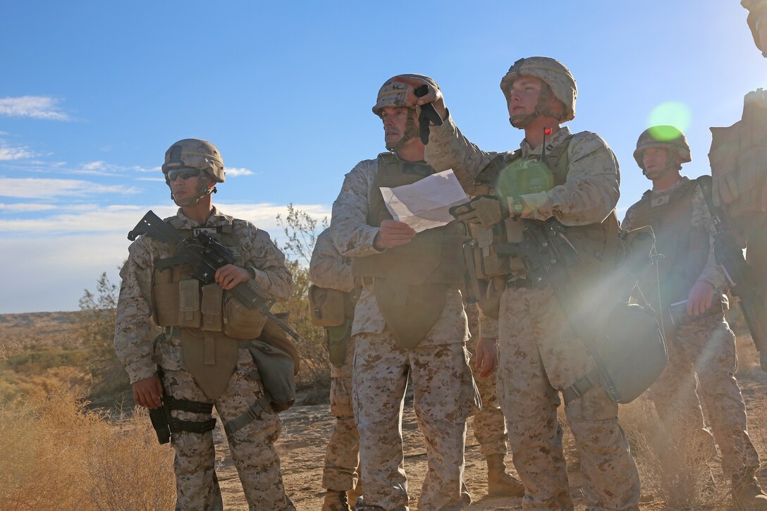Captain Charles Cain, Headquarters & Service Company commander, Combat Logistics Battalion 5, Combat Logistics Regiment 1, 1st Marine Logistics Group, left, provides Brigadier Gen. Vincent A. Coglianese, commanding general, 1st MLG, an update on current operations during Exercise Steel Knight 2014 aboard Marine Air Ground Combat Center Twentynine Palms, Calif., Dec. 11, 2013. CLB-5, alongside other units from 1st MLG and the 3rd Marine Aircraft Wing, provided support to 1st Marine Division training to fulfill the role of the Ground Combat Element of a Marines Air-Ground Task Force in future operations. 