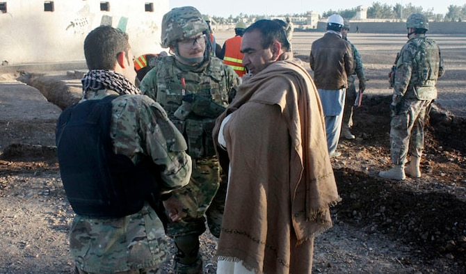 U.S. Air Force Capt. Clint Cooper, 838th Air Expeditionary Advisory Group comptroller advisor, speak with a village elder Dec. 2, 2013 about the water system construction in Old Russian Village near Shindand Air Base, Afghanistan. The water project, being overseen by the 838 AEAG Commander’s Emergency Response Program which began in October and will be completed in January 2014, will distribute clean, running water to more than 90 homes in the area and positively affect the lives of more than 600 village residents. (U.S. Air Force photo/Senior Master Sgt. Jonathan Wilkins) 