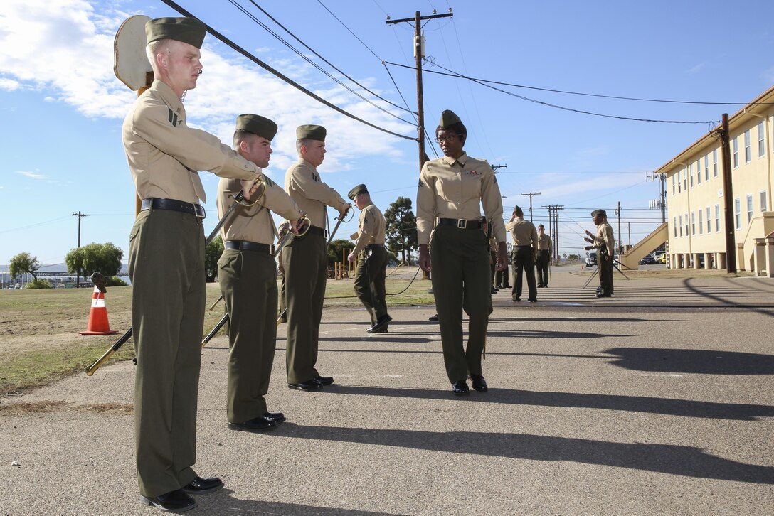 Corporal Ashton Tyler, right, warehouse clerk, 15th Marine Expeditionary Unit, inspects her classmates on sword manual at the Corporal’s Course Academy aboard Camp Pendleton, Calif., Dec. 10. The academy’s mission is to provide corporals with the education and leadership skills necessary to lead Marines. Tyler, 21, is from Charlestown, S.C. (U.S. Marine Corps photo by Cpl. Emmanuel 