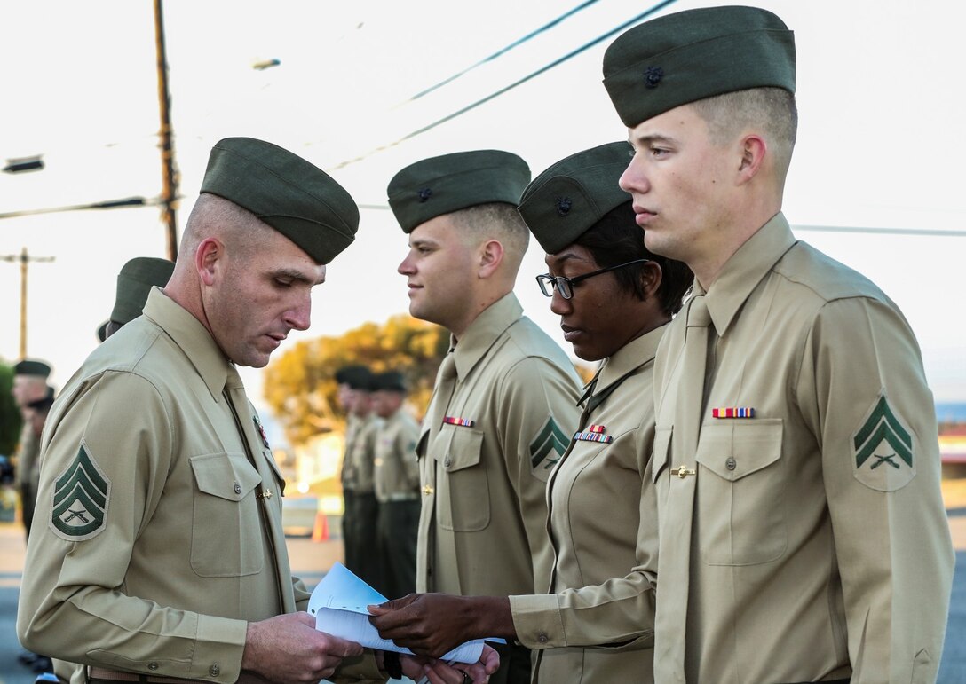 Staff Sgt. David McFadden, left, faculty advisor, Corporal’s Course Academy, conducts a uniform inspection on Cpl. Ashton Tyler, warehouse clerk, 15th Marine Expeditionary Unit, at the Corporal’s Course Academy aboard Camp Pendleton, Calif., Dec. 10. The academy’s mission is to provide corporals with the education and leadership skills necessary to lead Marines. McFadden, 32, is from Longview, Texas, Tyler, 21, is from Charlestown, S.C. (U.S. Marine Corps photo by Cpl. Emmanuel Ramos/Released)
