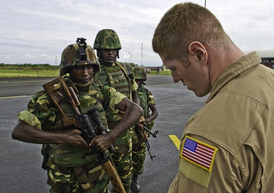 Senior Airman Corey McGrath, a Security Forces Phoenix Raven, ensures all weapons are clear before Burundi soldiers load onto a C-17 Globemaster Dec. 13, 2013 at Bujmumbura Airport, Burundi. In coordination with the French military and African Union, the U.S. military provided airlift support to transport Burundi soldiers, food and supplies in the Central African Republic (CAR). This support is aimed at enabling African forces to deploy promptly to prevent further spread of sectarian violence and restore security in the region.