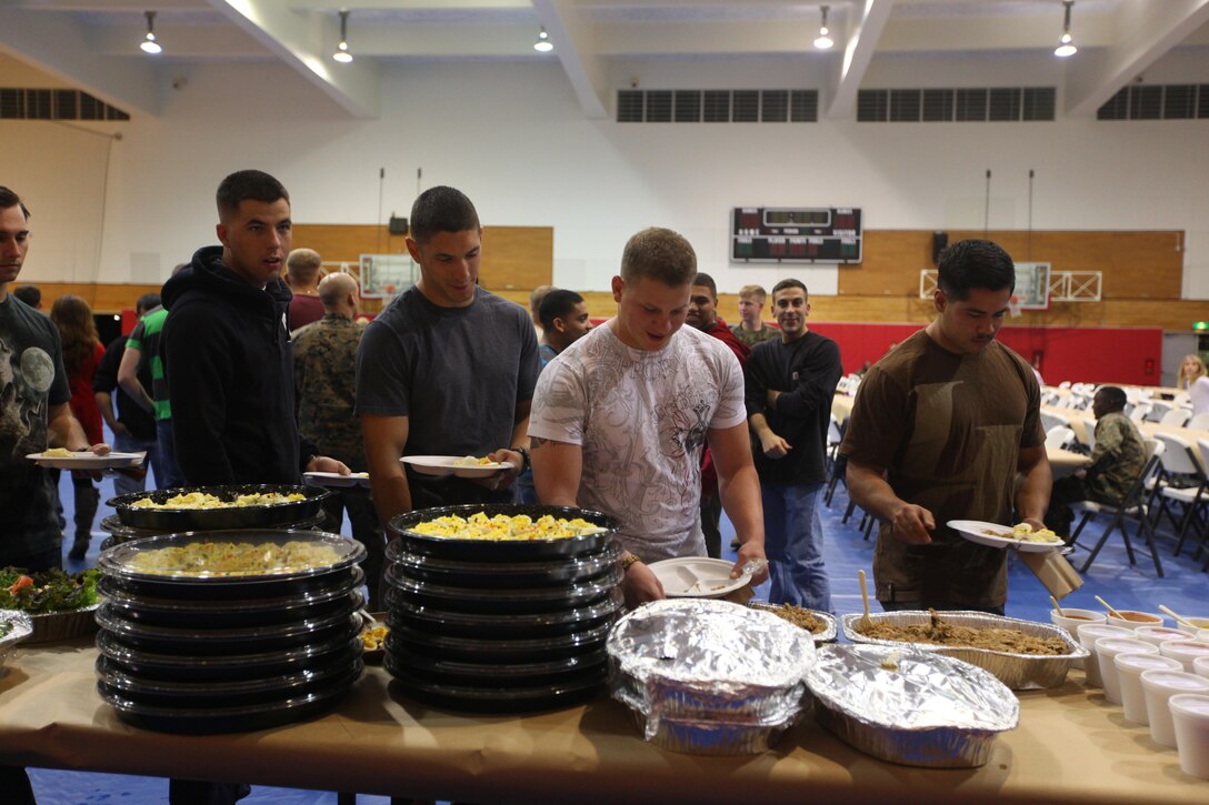 Marines help themselves to a banquet during the 31st Marine Expeditionary Unit’s Christmas party at the House of Pain gymnasium here, Dec. 12. The event provided an opportunity for the Marines and their families to spend time together, foster camaraderie and enjoy the holiday spirit.  The 31st MEU is the Marine Corps’ force in readiness in the Asia-Pacific region and is the only continuously forward-deployed MEU. 