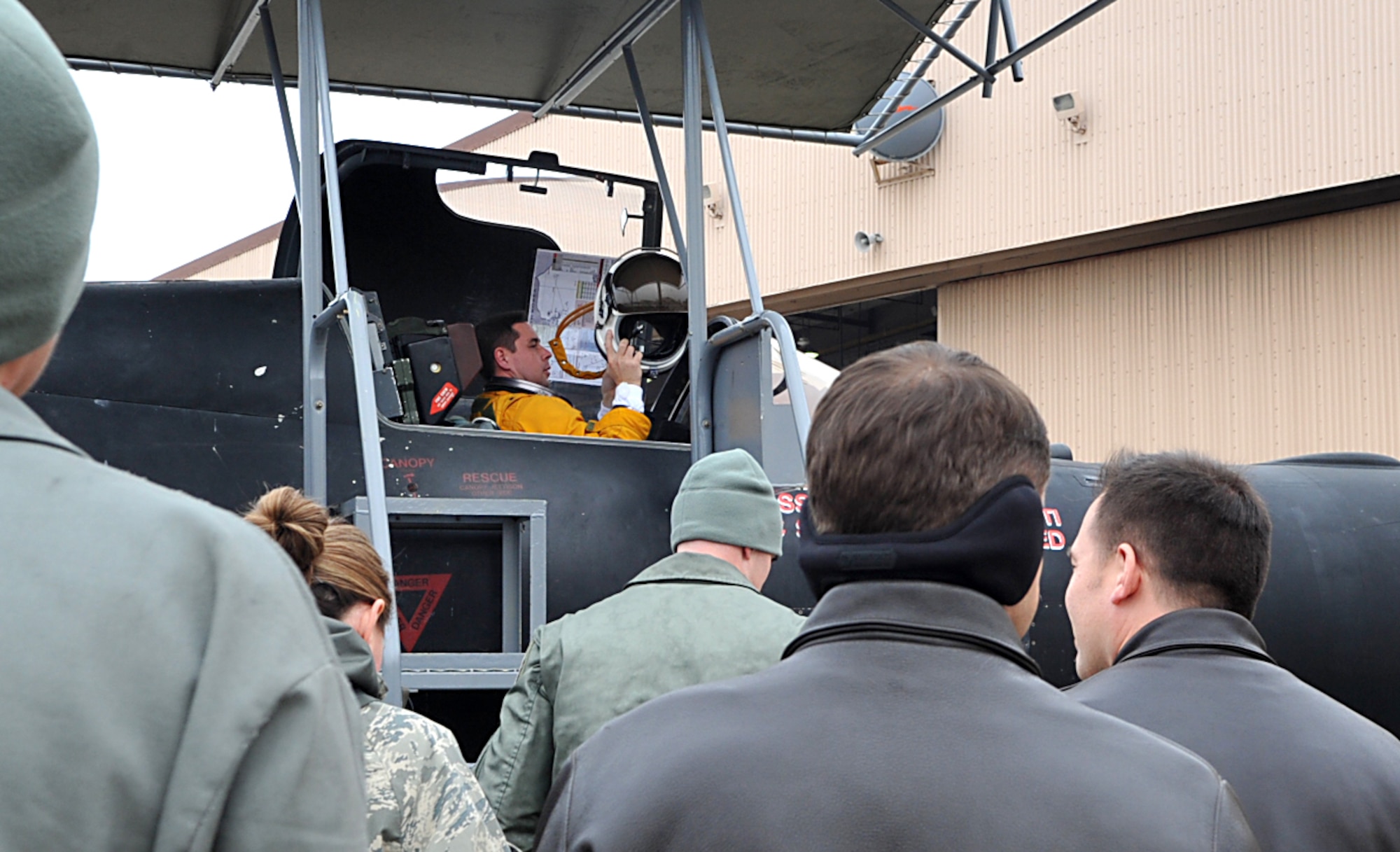 Lt. Col. David (last name withheld due to operational security constraints) 5th Reconnaissance Squadron U-2 Dragon Lady pilot, removes his helmet after reaching 1,500 flying hours at Osan Air Base, Republic of Korea, Dec. 16, 2013. David was greeted with cheers and applause from his entire squadron, in keeping with the tradition of all U-2 squadrons to welcome pilots back from their missions. (U.S. Air Force photo/Airman 1st Class Ashley J. Thum)