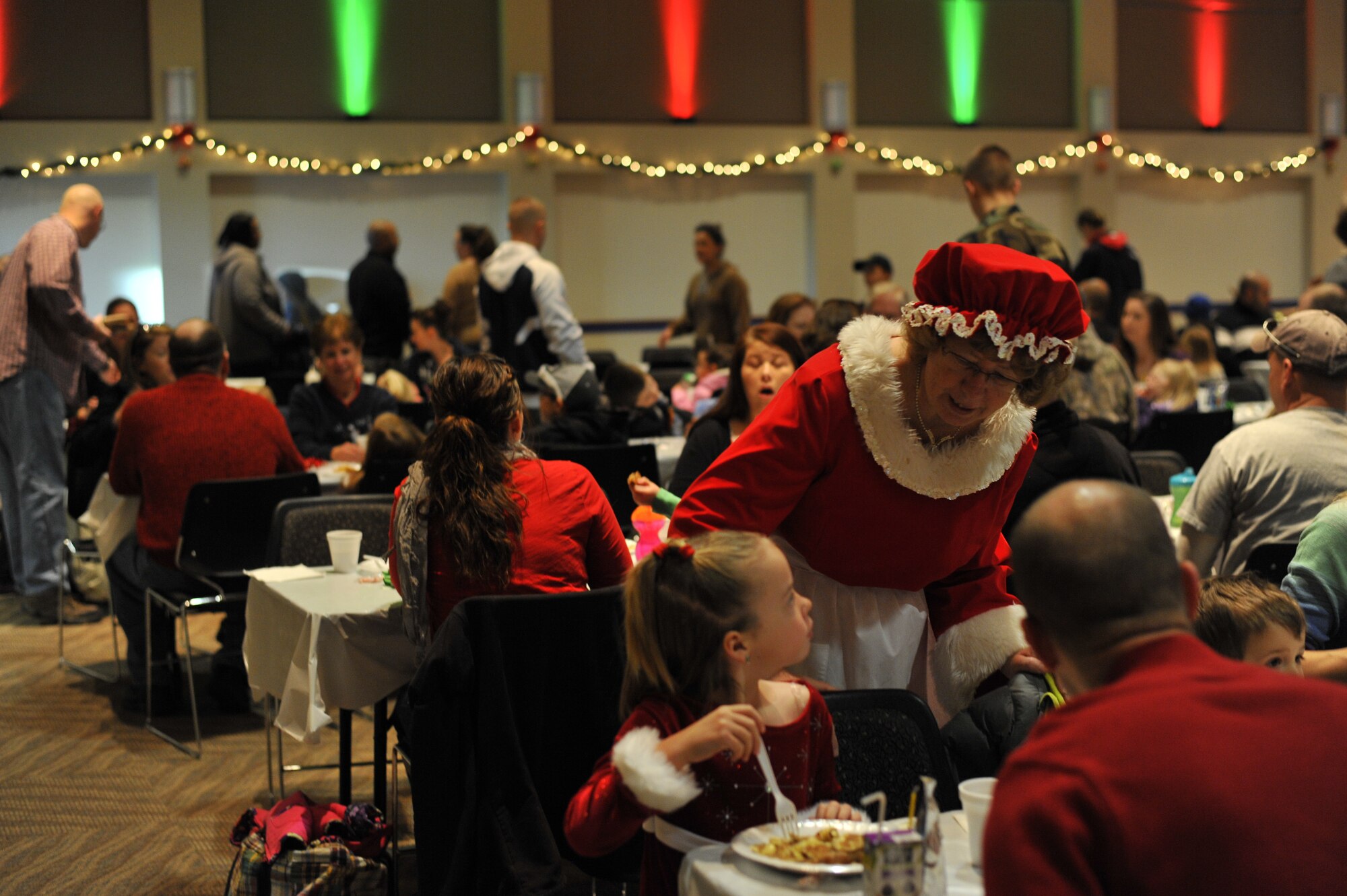 Mrs. Claus visits each table at the Breakfast with Santa event spreading hugs and smiles to each family that attended Dec. 14, 2013, at the Leadership Development Center on Buckley Air Force Base, Colo. Breakfast with Santa is an annual event coordinated by the 460th Force Support Squadron that provides families with a pancake breakfast, a visit with Santa, and a gift to every child. (U.S. Air Force Photo by Airman 1st Class Samantha Saulsbury/Released)