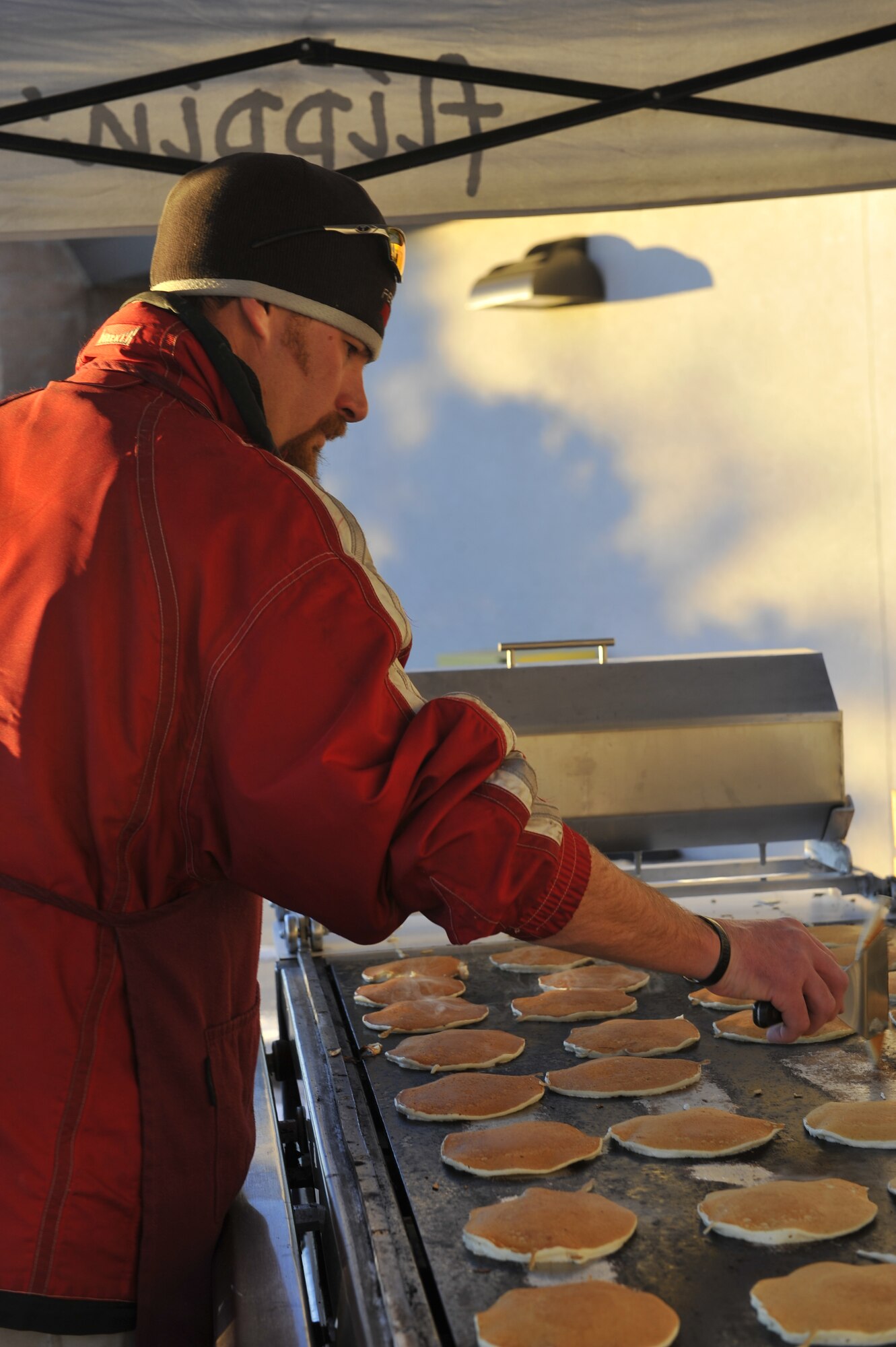 Dan Kuper, owner of Flippin’ Flapjacks, a local business out of Centennial, Colo., cooks pancakes for the families that attended Breakfast with Santa Dec. 14, 2013, at the Leadership Development Center on Buckley Air Force Base, Colo. Breakfast with Santa is an annual event coordinated by the 460th Force Support Squadron that provides families with a pancake breakfast, a visit with Santa, and a gift to every child. (U.S. Air Force Photo by Airman 1st Class Samantha Saulsbury/Released)