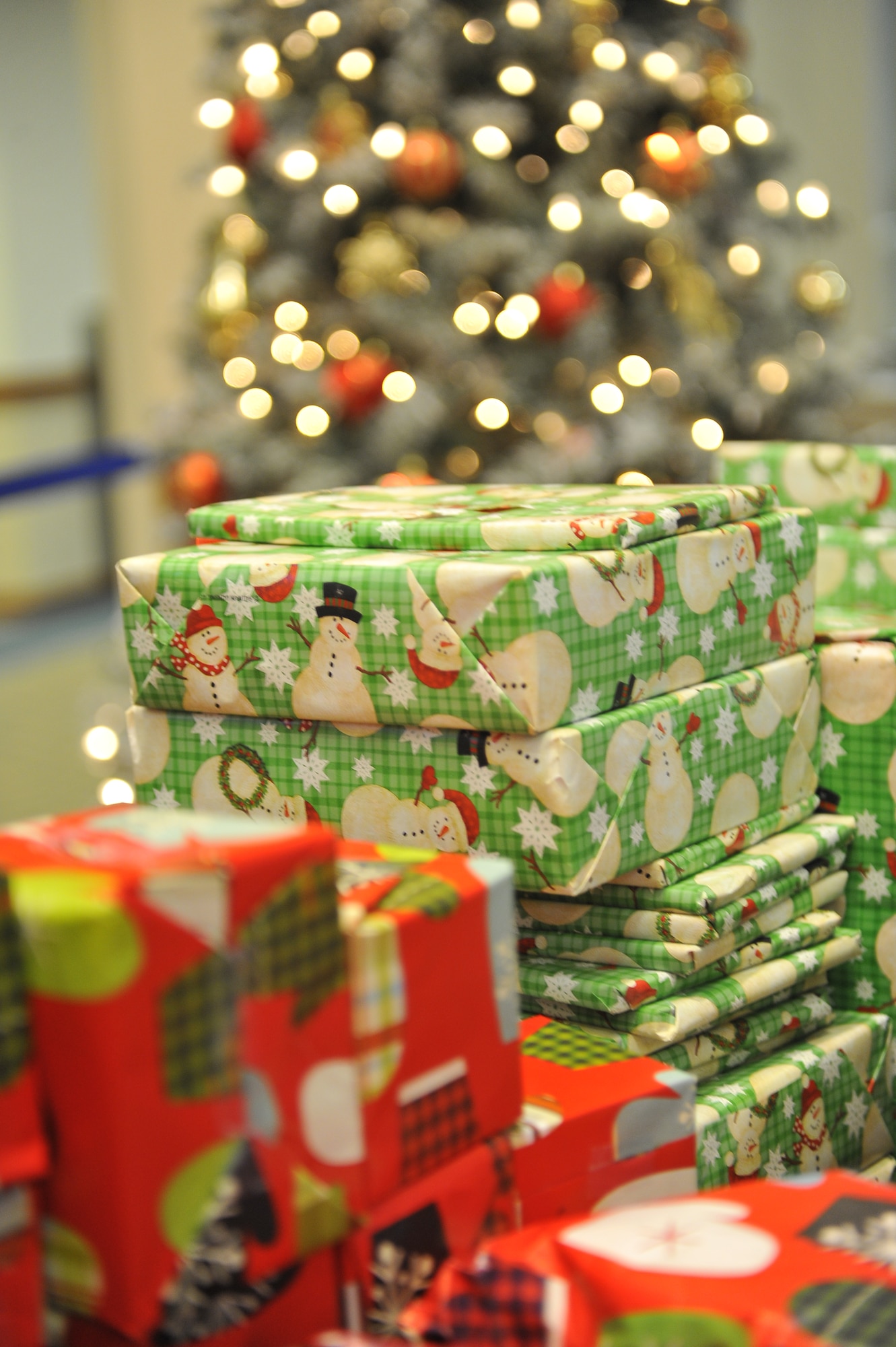 Team Buckley members wrapped presents for the children attending the Breakfast with Santa event Dec. 14, 2013, at the Leadership Development Center on Buckley Air Force Base, Colo. Breakfast with Santa is an annual event coordinated by the 460th Force Support Squadron that provides families with a pancake breakfast, visit with Santa and gift to every child in attendance. (U.S. Air Force Photo by Airman 1st Class Samantha Saulsbury/Released)