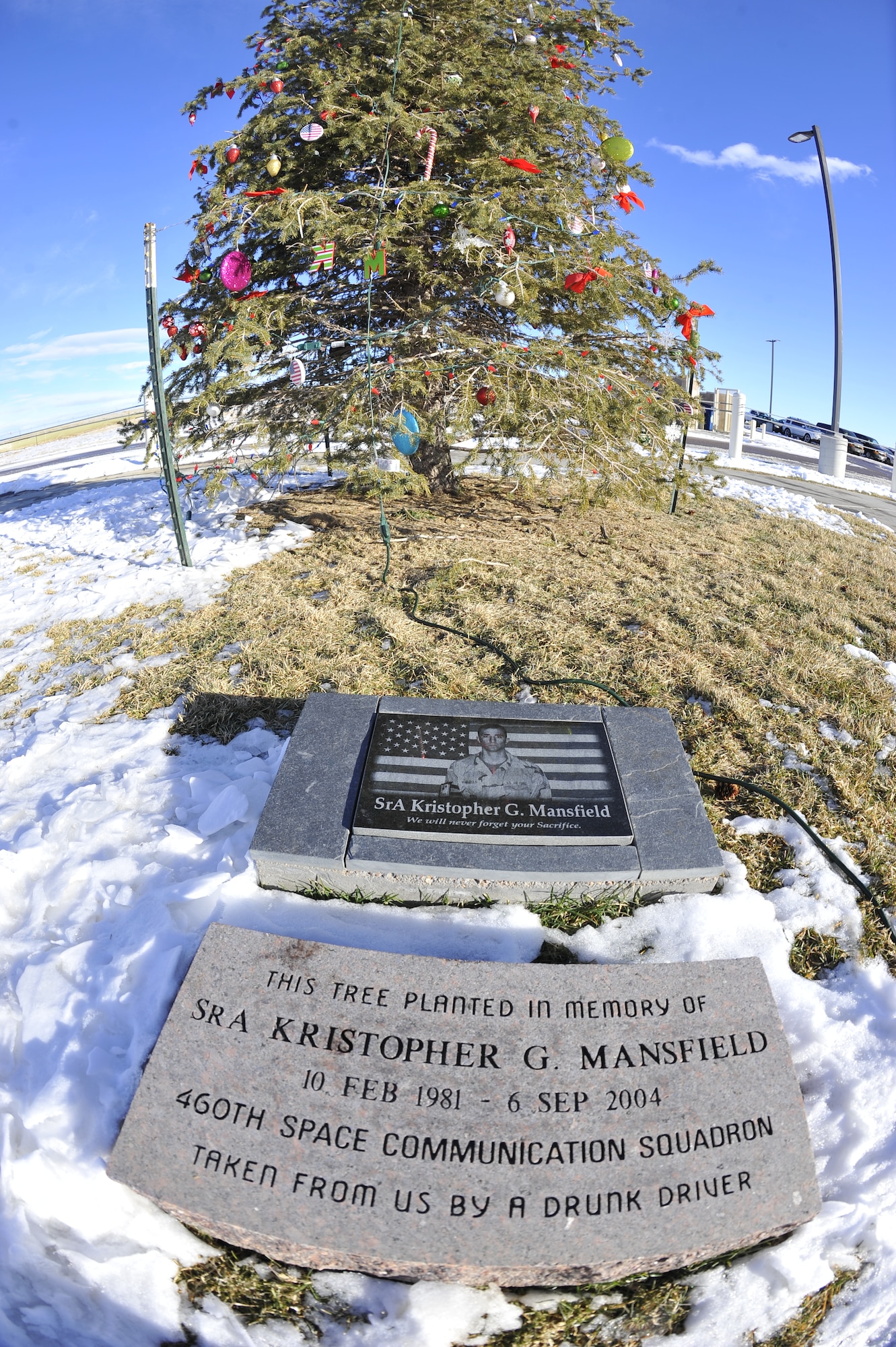 A tree is lit Dec. 9, 2013, on Buckley Air Force Base, Colo., during a tree-lighting ceremony in memory of Kristopher Mansfield, a former 460th Space Communications Squadron Airman who was killed by a drunk driver. Family and friends decorate the tree in celebration of Mansfield’s life and what he meant to the squadron. (U.S. Air Force photo by Airman 1st Class Samantha Saulsbury/Released)