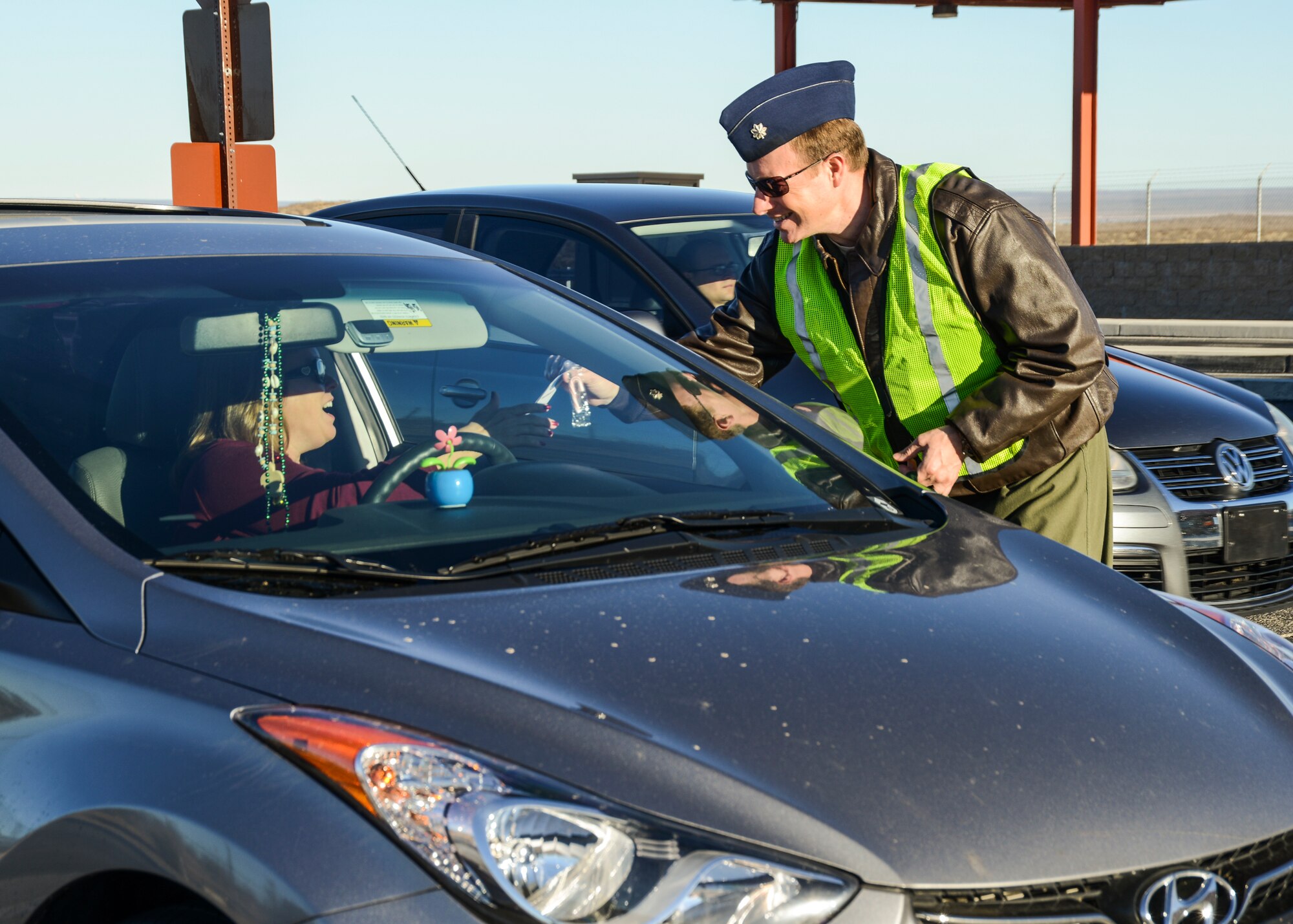 Lt. Col. Devin Traynor, 411th Flight Test Squadron commander, handed out candy canes and safety pamphlets to encourage people to enjoy the holidays safely Dec. 13. (U.S. Air Force photo by Rebecca Amber)