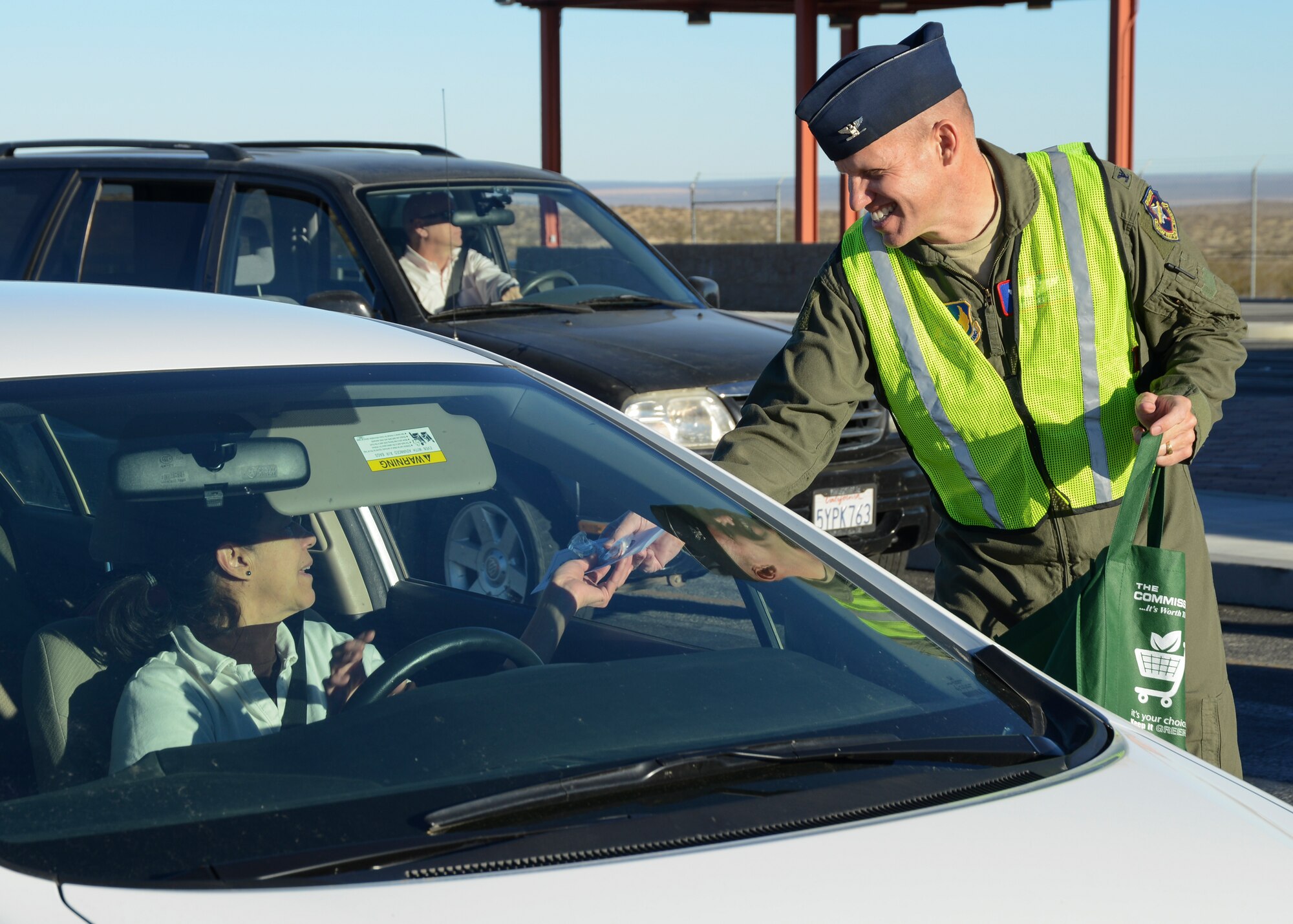 Col. Evan Dertien, Air Force Test Center vice commander, wished people leaving the West Gate happy holidays as they left Dec. 13. (U.S. Air Force photo by Rebecca Amber)