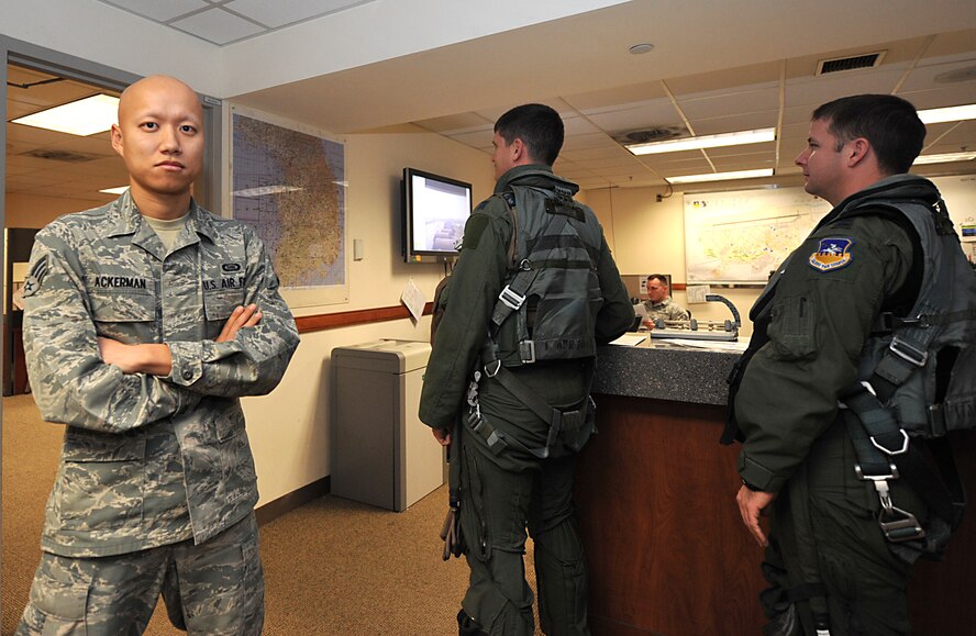 Senior Airman Stevie Ackerman, 25th Fighter Squadron intelligence analyst, poses near the 25th FS operations desk at Osan Air Base, Republic of Korea, Dec. 10, 2013. Ackerman is this week's Airman Spotlight winner.  (U.S. Air Force photo/Airman 1st Class Ashley J. Thum)
