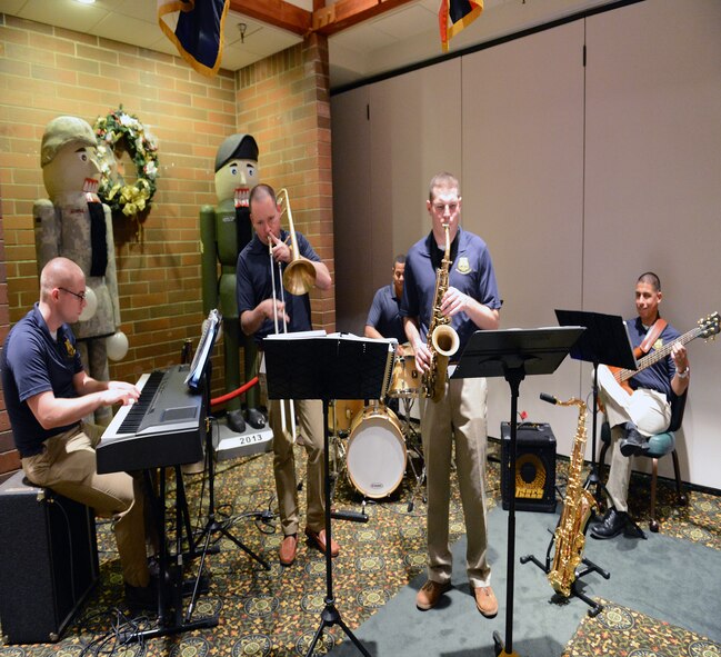 The 56th Army Band jazz combo from Joint Base Lewis-McChord, Wash., play a Christmas carol at the civic leader’s holiday reception Dec. 15, at Joint Base Lewis-McChord. Civic leaders enjoyed live music, a social hour and hors d'oeuvres. (U.S. Air Force photo/ Airman 1st Class Jacob Jimenez)    