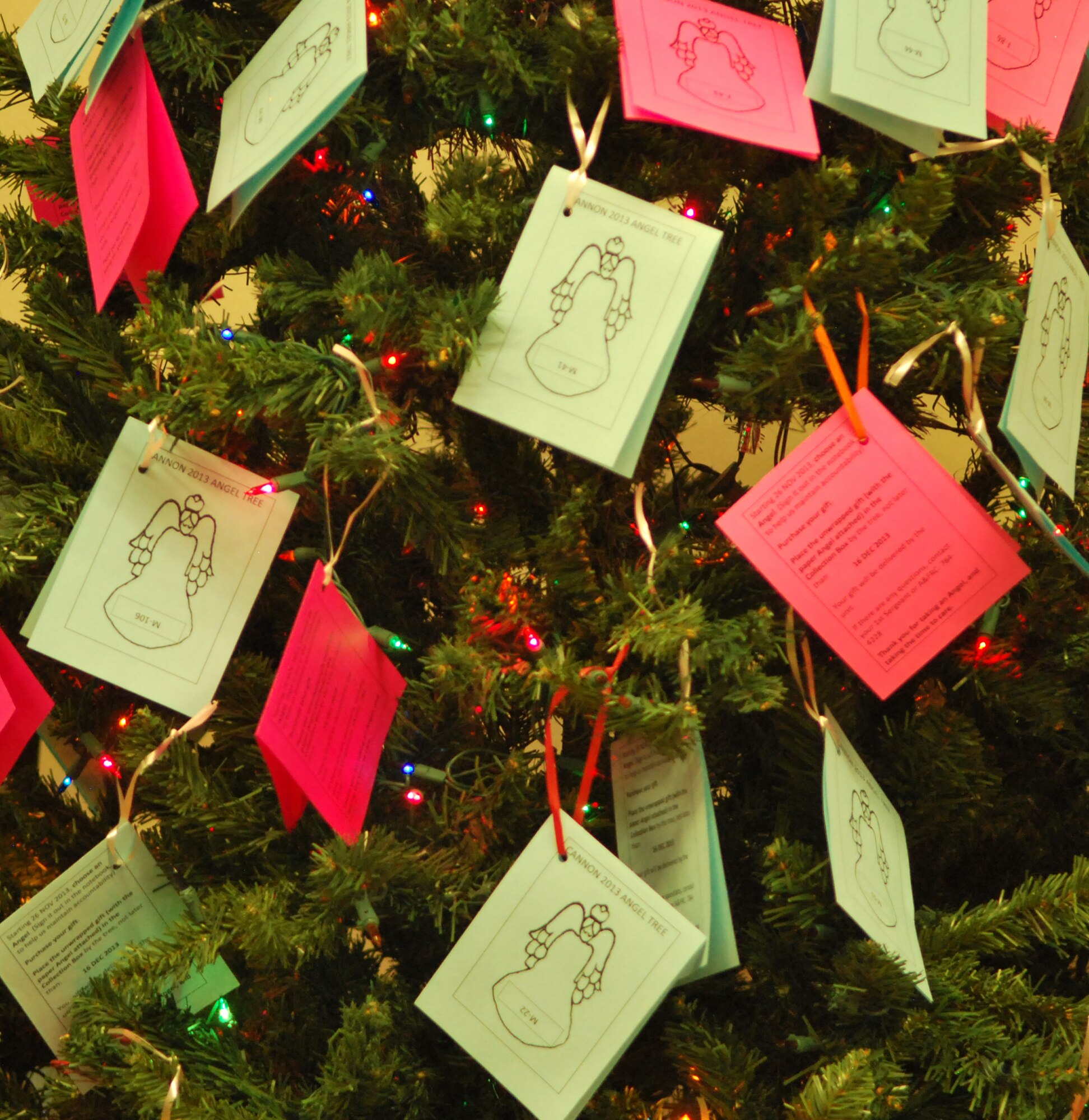 The Angel Tree, decorated with "angels" in need of sponsors during the holiday season, is on display Dec. 3, 2013, in the Exchange, at Cannon Air Force Base, N.M.  The Angel Tree program's goal is to make sure that every child in the Cannon community receives a present this year. Angel Tree gifts were accepted at the collection box near the tree until noon, Dec. 16. (U.S. Air Force photo/Desiree Ann Montenegro)