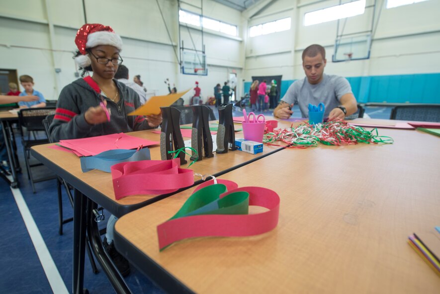 Moody Air Force Base, Ga., volunteers make Christmas ornaments during the 23d Force Support Squadron’s annual Breakfast with Santa, Dec. 14, 2013. During the event, Santa met with children and gave them ornaments.  (U.S. Air Force photo by Airman Dillian Bamman/Released)