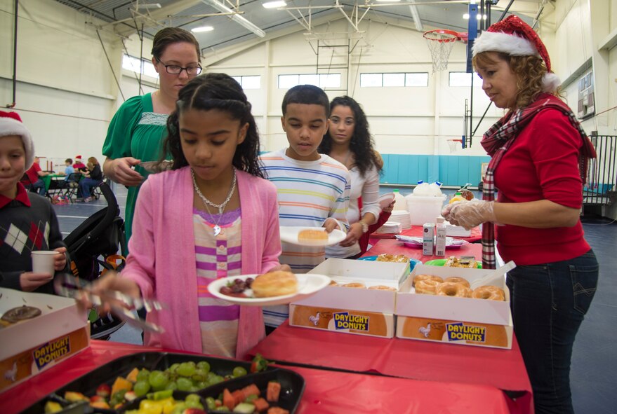 Families of the Moody Air Force Base, Ga., community choose their breakfast items during the 23d Force Support Squadron’s annual Breakfast with Santa, Dec. 14, 2013. The event included a visit with Santa Claus, which allowed children to take pictures with him and tell him their Christmas wishes. (U.S. Air Force photo by Airman Dillian Bamman/Released)