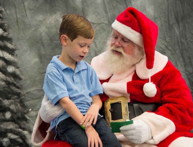 Joshua shows Santa Claus his Christmas list during the 23d Force Support Squadron’s annual Breakfast with Santa at the Youth Center on Moody Air Force Base, Ga., Dec. 14, 2013. Joshua told Santa what he hoped for this Christmas. (U.S. Air Force photo by Airman Dillian Bamman/Released)