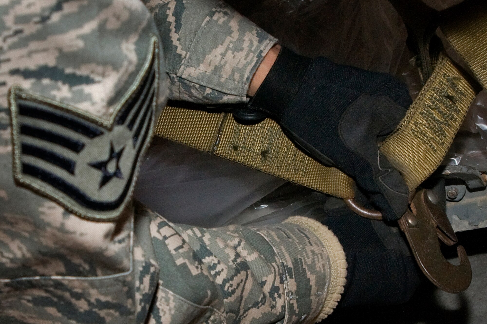 Staff Sgt. Shawn Canning, 434th Logistics Readiness Squadron vehicle operator secures a cargo net over boxes of food bound for Haiti at Grissom Air Reserve Base, Ind., Dec. 7, 2013. Grissom's Air Force reservists partnered with Airmen from Joint Base McGuire-Dix-Lakehurst N.J., and Charleston AFB, S.C., to provide more than 45,000 pounds of food to Haiti as part of a humanitarian relief mission under the Denton Program.  (U.S. Air Force photo/Senior Airman Jami K. Lancette)
