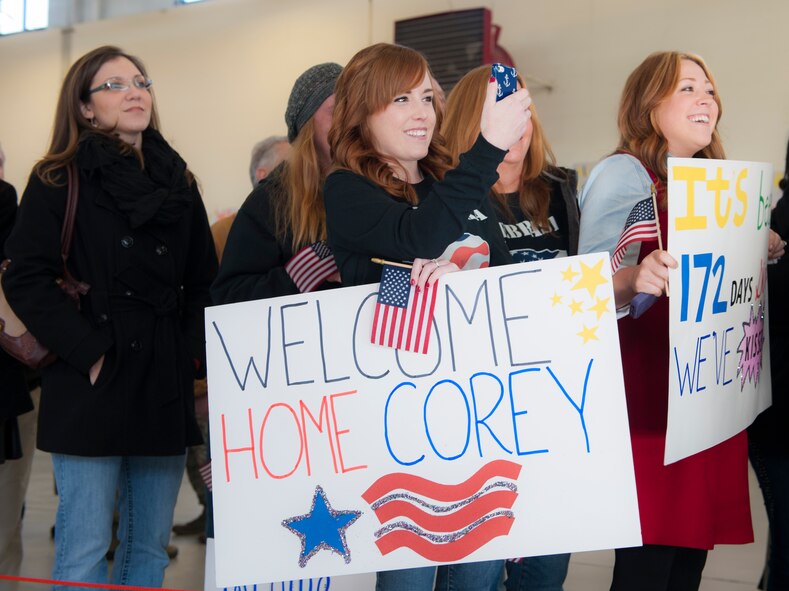 Families and friends wait for their Airmen to return to Moody Air Force Base, Ga., Dec. 16 2013. Approximately 150 Airmen from the 823d Base Defense Squadron returned from a six-month deployment to Bagram Airfield, Afghanistan. (U.S. Air Force Airman 1st Class Alexis Grotz/ Released)