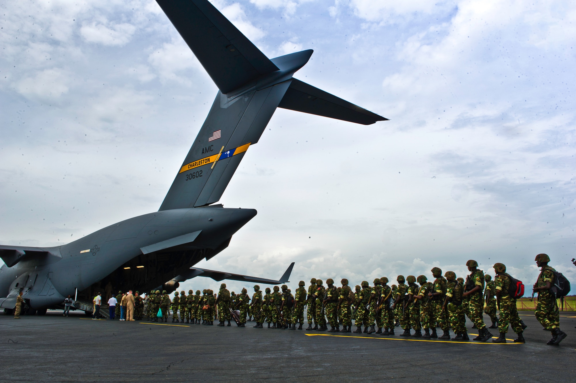 Burundi soldiers prepare to load onto a C-17 Globemaster Dec. 13, 2013 at Bujmumbura Airport, Burundi. In coordination with the French military and African Union, the U.S. military provided airlift support to transport Burundi soldiers, food and supplies in the Central African Republic. This support is aimed at enabling African forces to deploy promptly to prevent further spread of sectarian violence and restore security in CAR. (U.S. Air Force photo/Staff Sgt. Erik Cardenas)